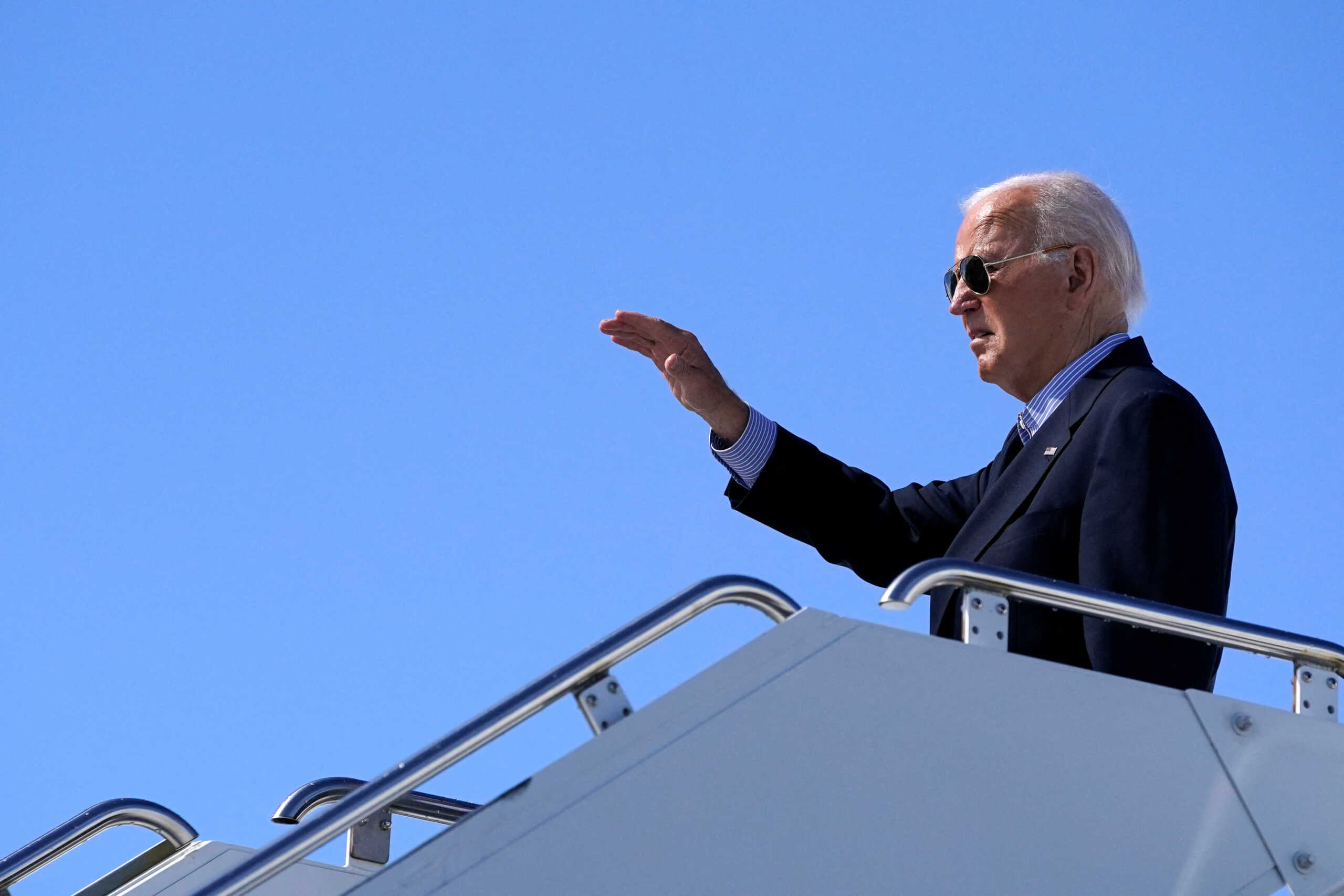 U.S. President Joe Biden waves while boarding Air Force One at Dane County Regional Airport, in Madison, Wisconsin, U.S., July 5, 2024. REUTERS
