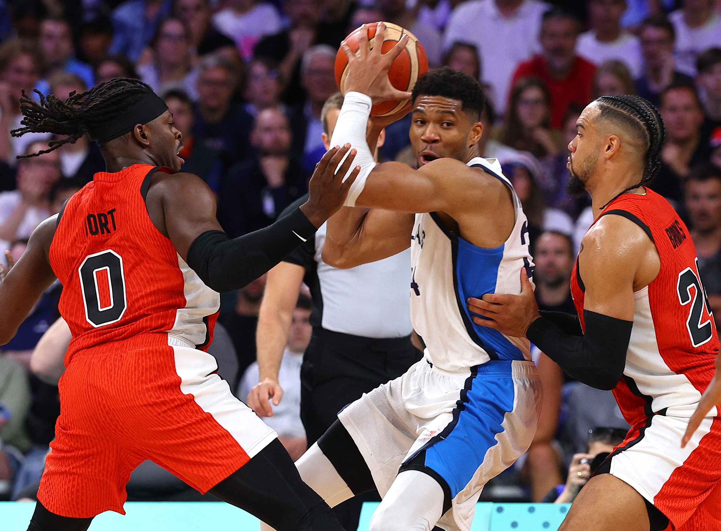 Paris 2024 Olympics - Basketball - Men's Group Phase - Group A - Greece vs Canada - Lille, Pierre Mauroy Stadium, Villeneve-d'Ascq, France - July 27, 2024. Giannis Antetokounmpo of Greece in action against Dillon Brooks of Canada and Luguentz Dort of Canada. REUTERS