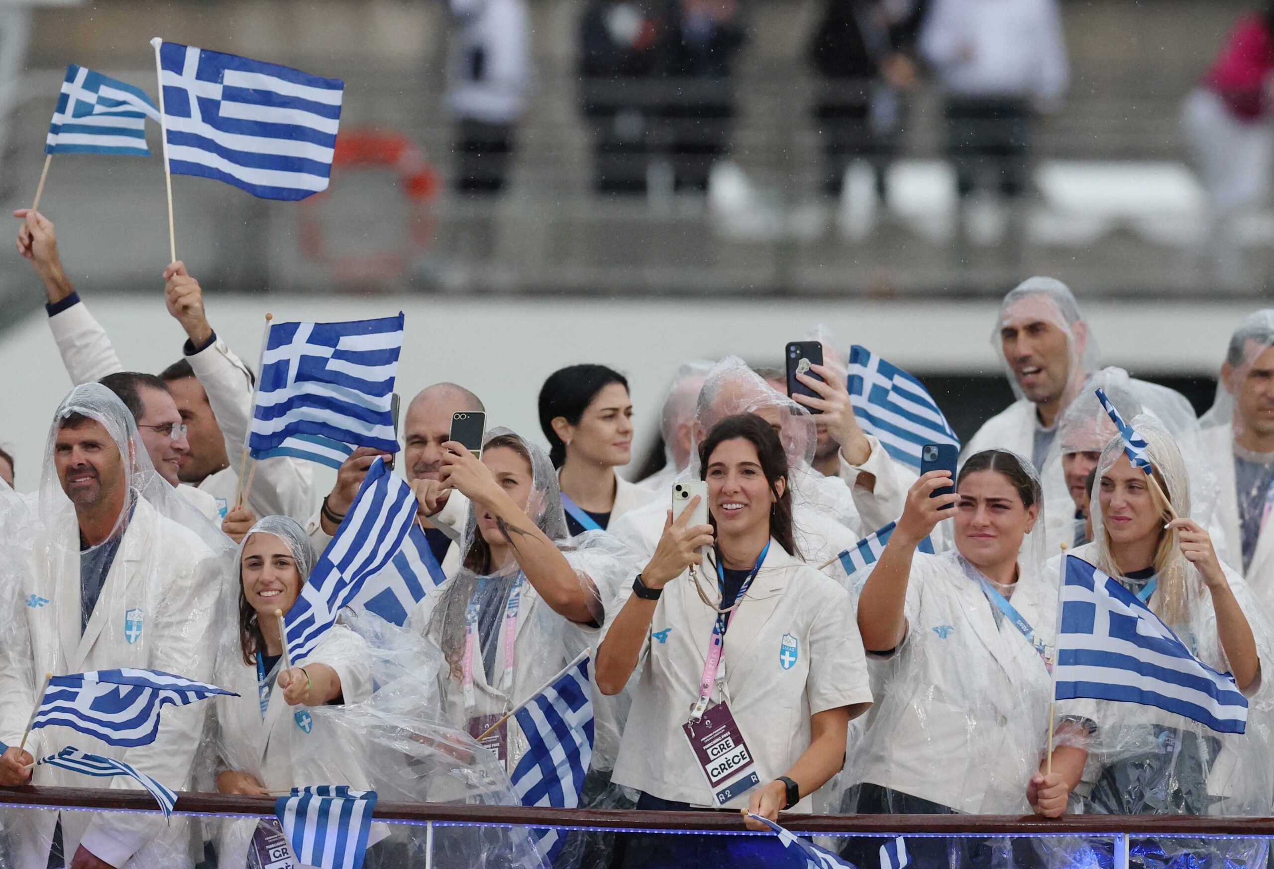 Paris 2024 Olympics - Opening Ceremony - Paris, France - July 26, 2024. Athletes of Greece aboard a boat in the floating parade on the river Seine during the opening ceremony. REUTERS