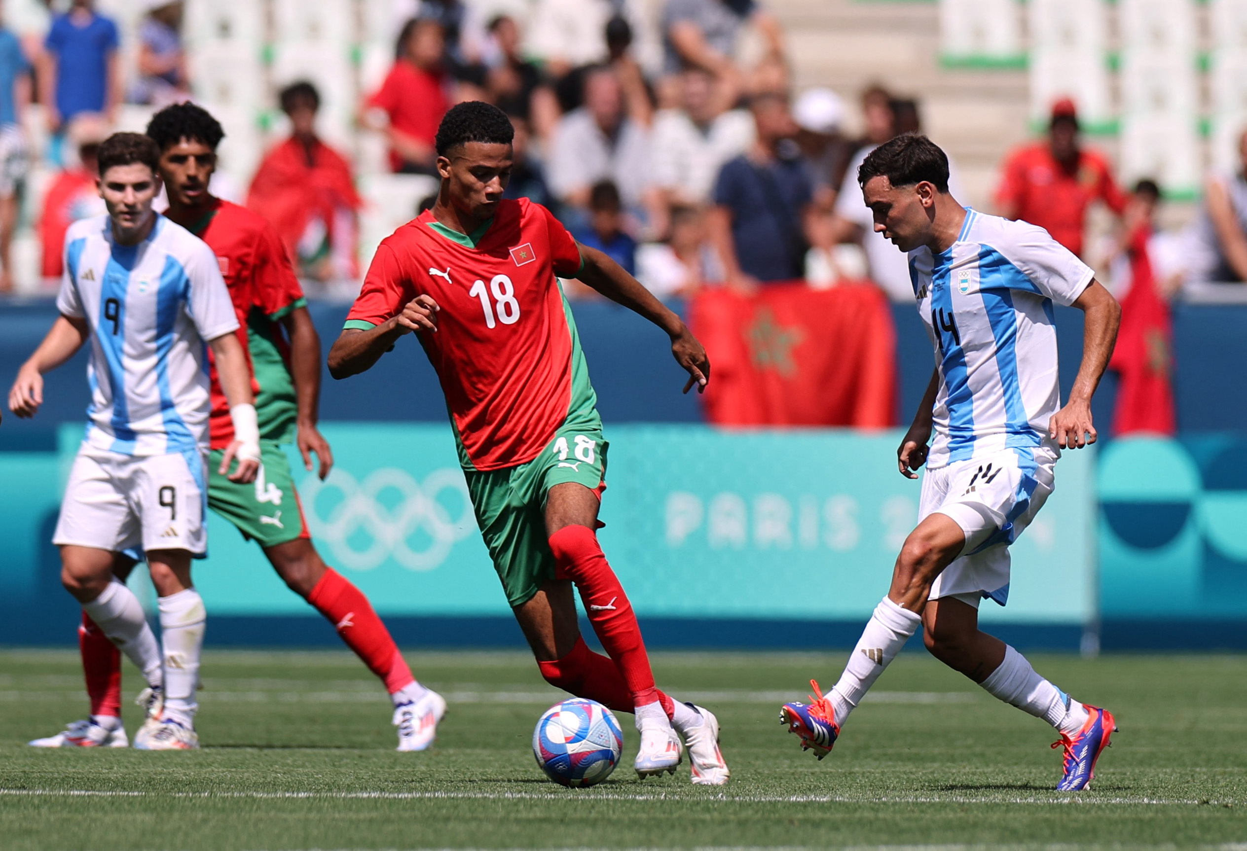 Paris 2024 Olympics - Football - Men's Group B - Argentina vs Morocco - Geoffroy-Guichard Stadium, Saint-Etienne, France - July 24, 2024. Santiago Hezze of Argentina in action with Amir Richardson of Morocco REUTERS