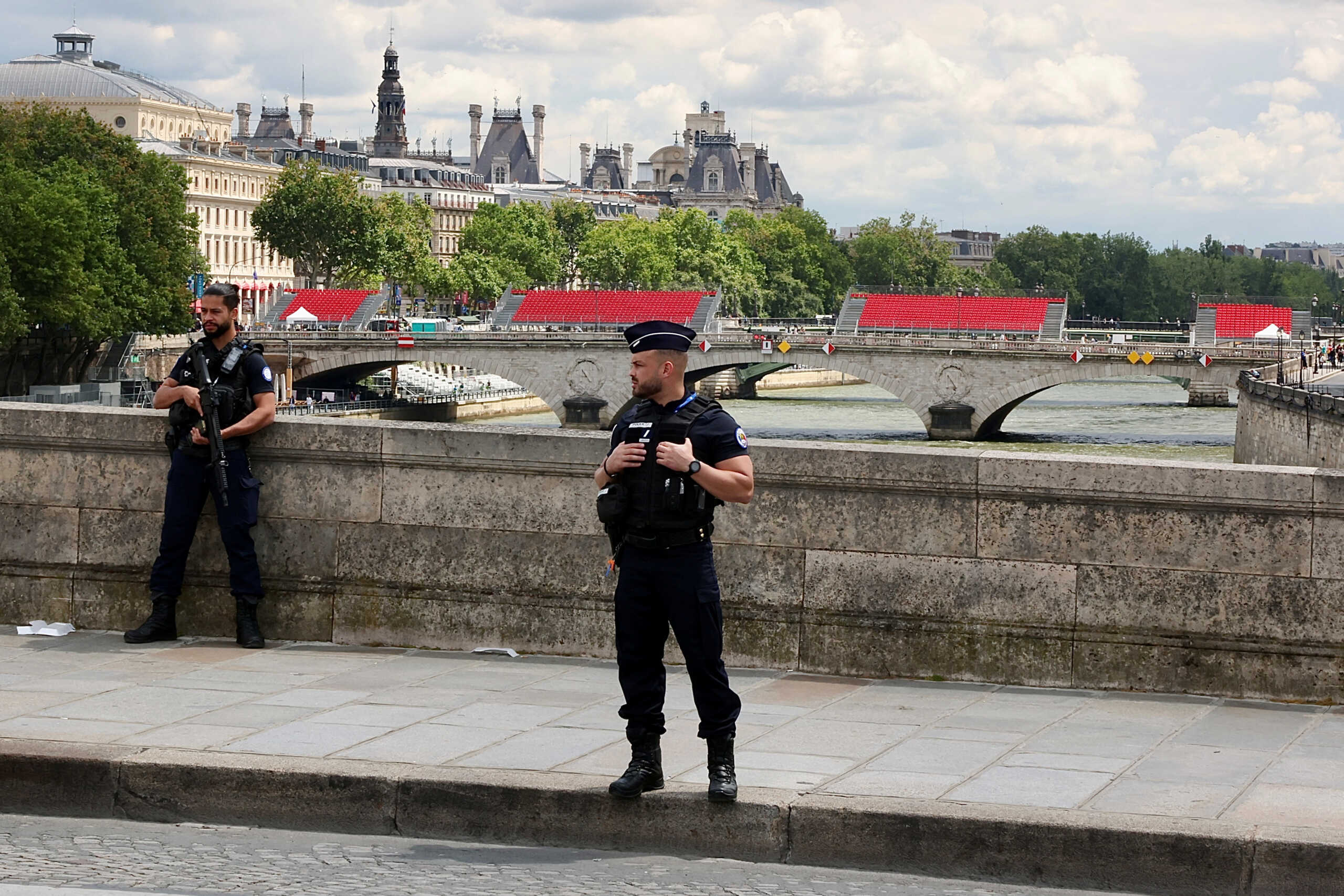 Police stand near spectator seating on the Pont Notre Dame ahead of the Paris 2024 Olympics and Paralympics Games in Paris, France, July 13, 2024. REUTERS