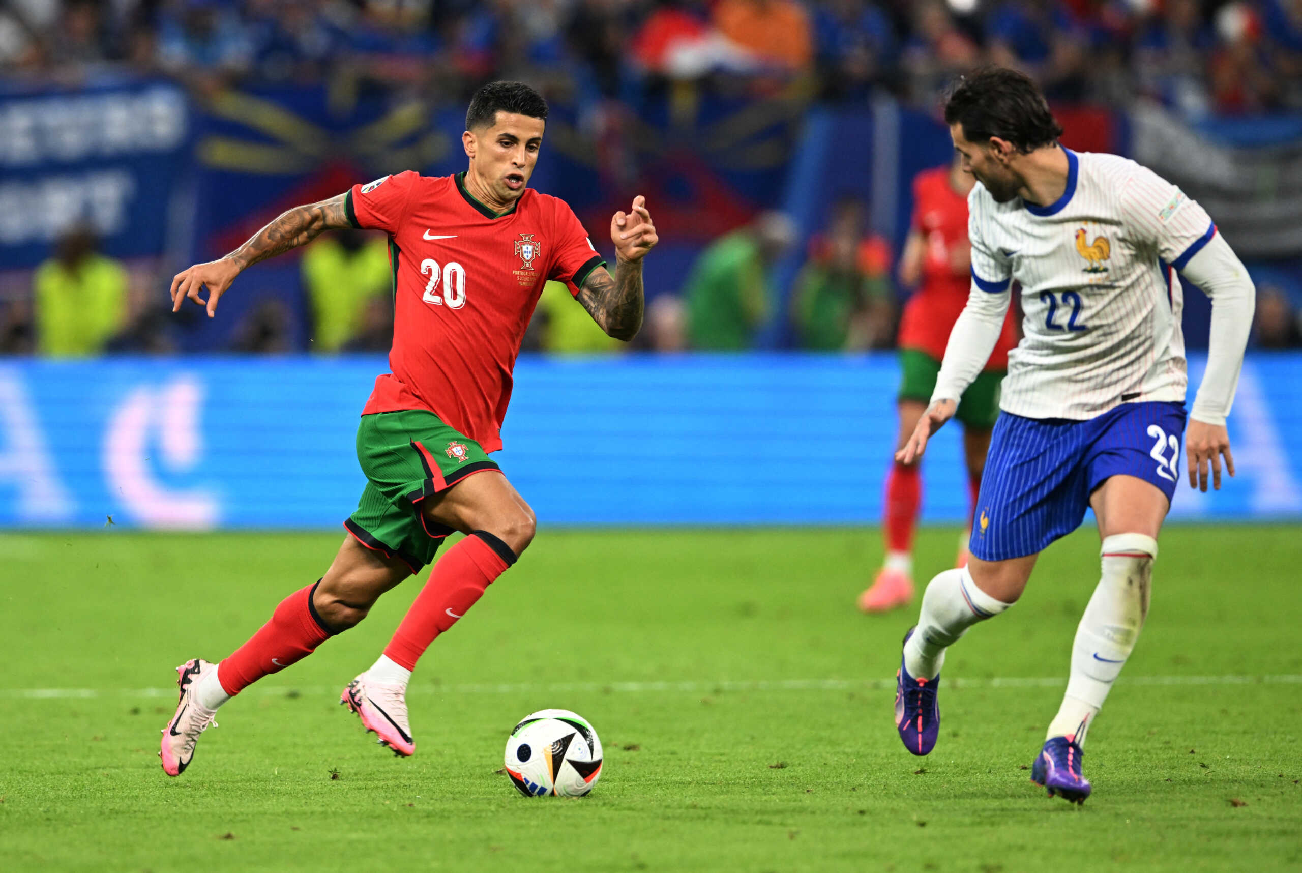 Soccer Football - Euro 2024 - Quarter Final - Portugal v France - Hamburg Volksparkstadion, Hamburg, Germany - July 5, 2024 Portugal's Joao Cancelo in action with France's Theo Hernandez REUTERS