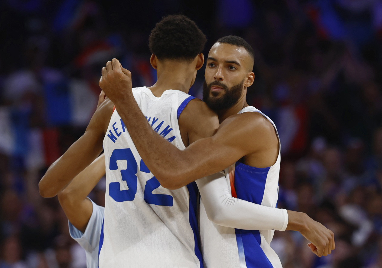 Paris 2024 Olympics - Basketball - Men's Group Phase - Group B - France vs Brazil - Lille, Pierre Mauroy Stadium, Villeneve-d'Ascq, France - July 27, 2024. Victor Wembanyama of France and Rudy Gobert of France celebrate after the match REUTERS