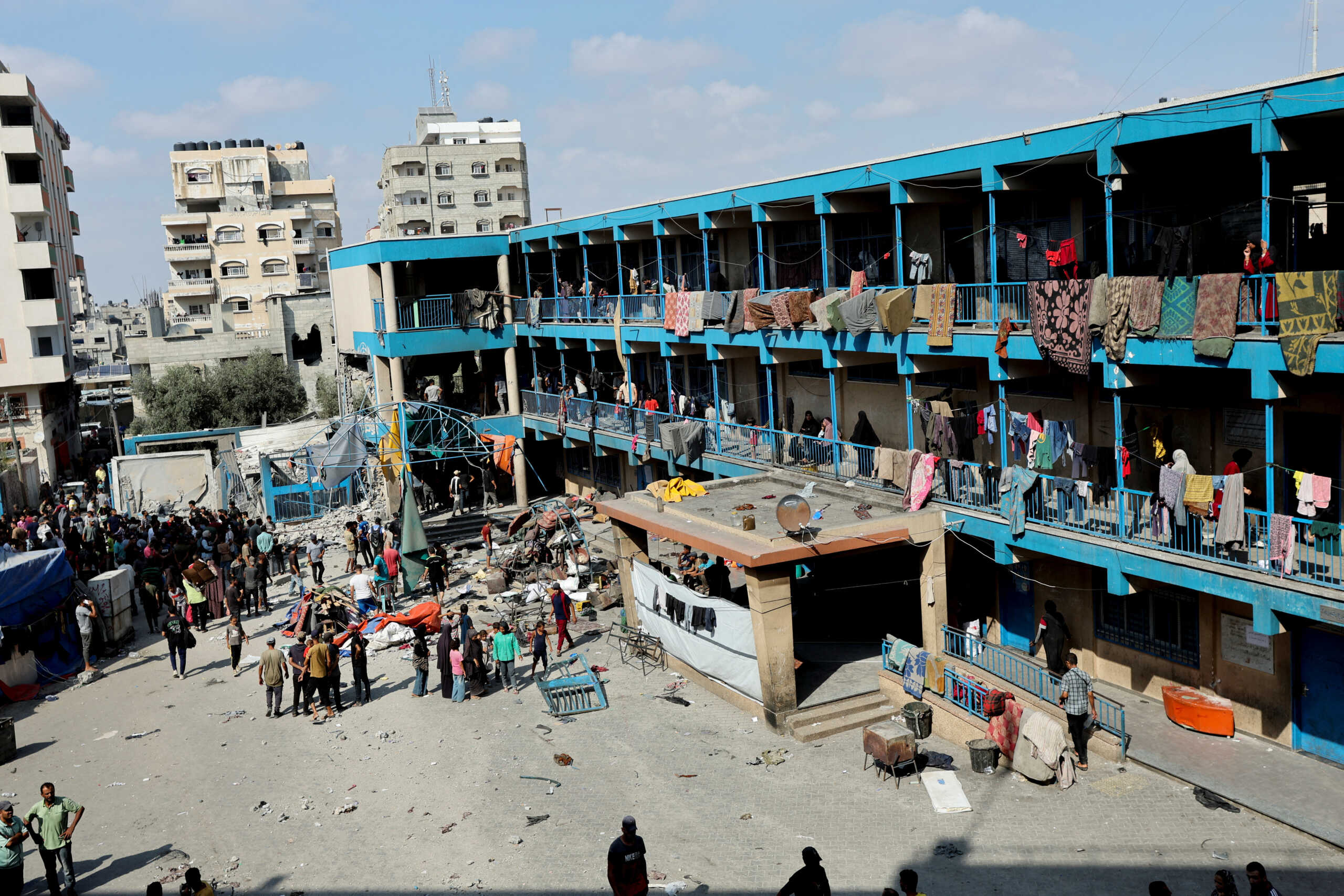 Palestinians gather at the site of an Israeli air strike on a UN school sheltering displaced people, amid the Israel-Hamas conflict, in Nusairat in central Gaza Strip, July 14, 2024. REUTERS