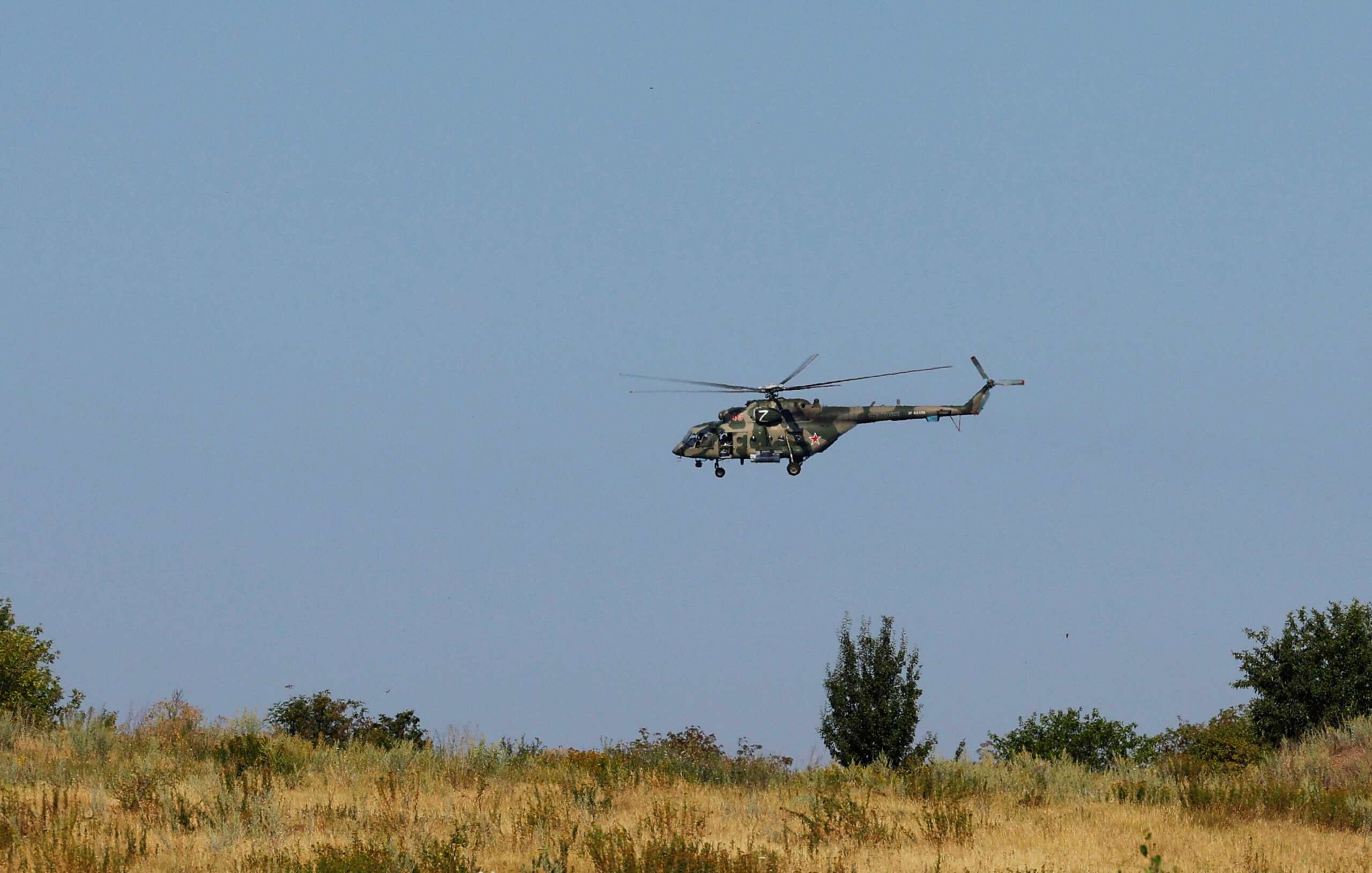 Russian military helicopter flies during a ceremony marking the 10th anniversary of the Malaysia Airlines Flight MH17 plane crash, near the village of Hrabove (Grabovo) in the Donetsk region, Russian-controlled Ukraine, July 17, 2024. REUTERS