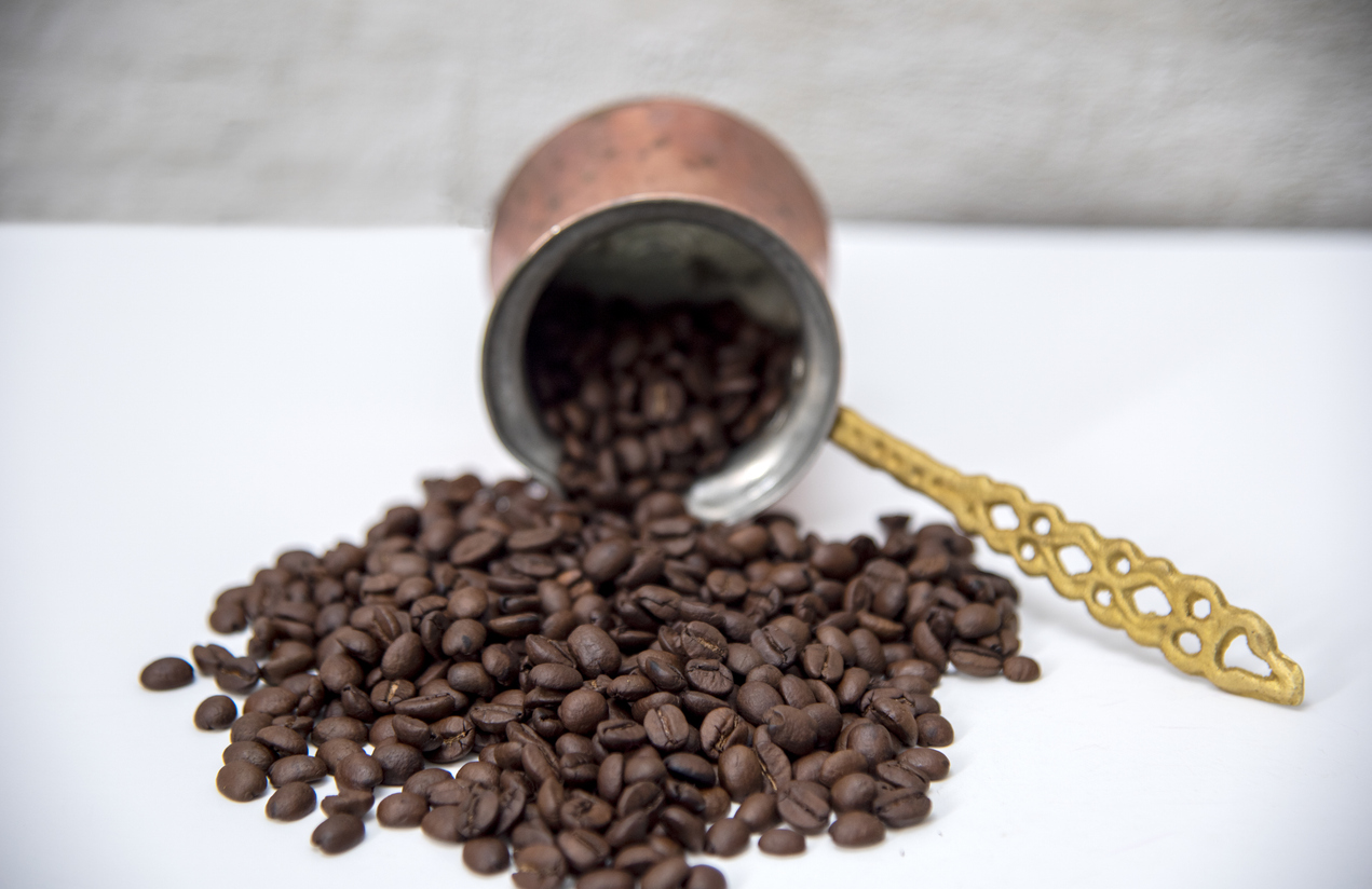 Direct above view of roasted coffee beans, coffe pot for Turkish coffee