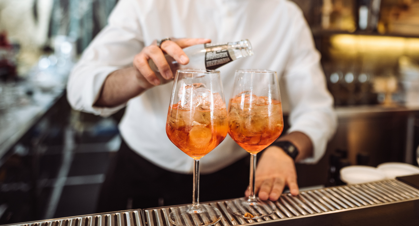 bartender preparing a drink in front at the bar counter