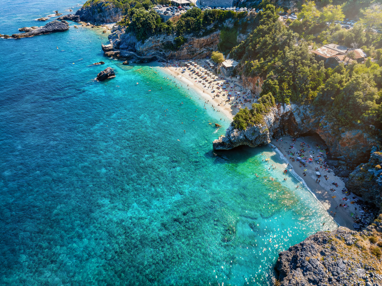Aerial top view of the beautiful beach at Mylopotamos, Pelion mountains, Greece, with emerald shning sea