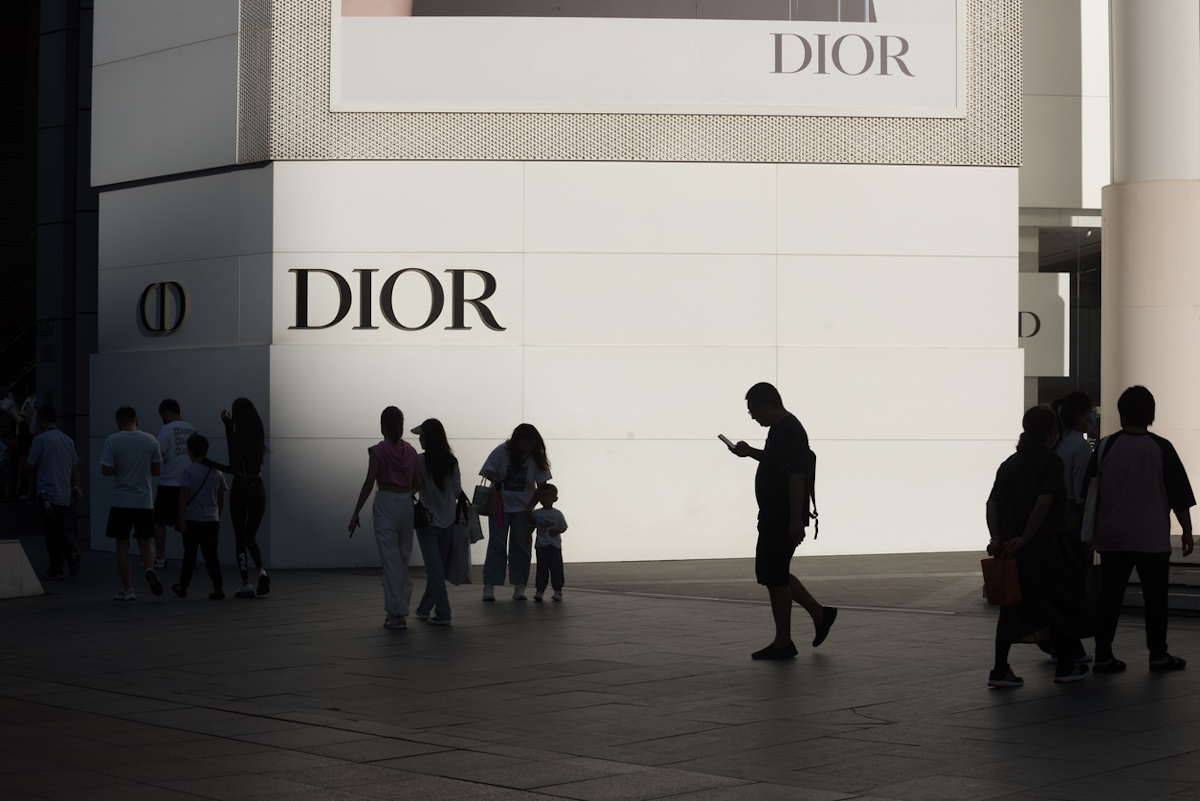 Shanghai, China - September 01, 2023: Pedestrians in front of a Dior billboard on Nanjing East Road Pedestrian Street in Shanghai