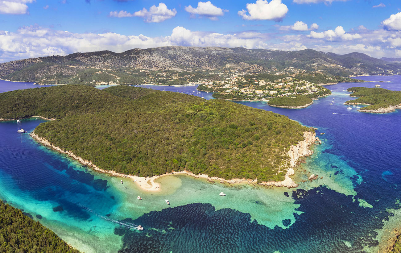Sivota - stunning aerial drone video of turquoise sea known as Blue Lagoon and unique beach Bella Vraka. Epirus, Greece