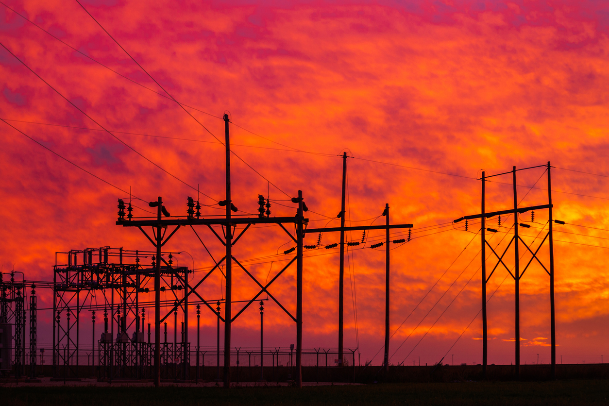 fiery sunset with power station collection grid silhouette