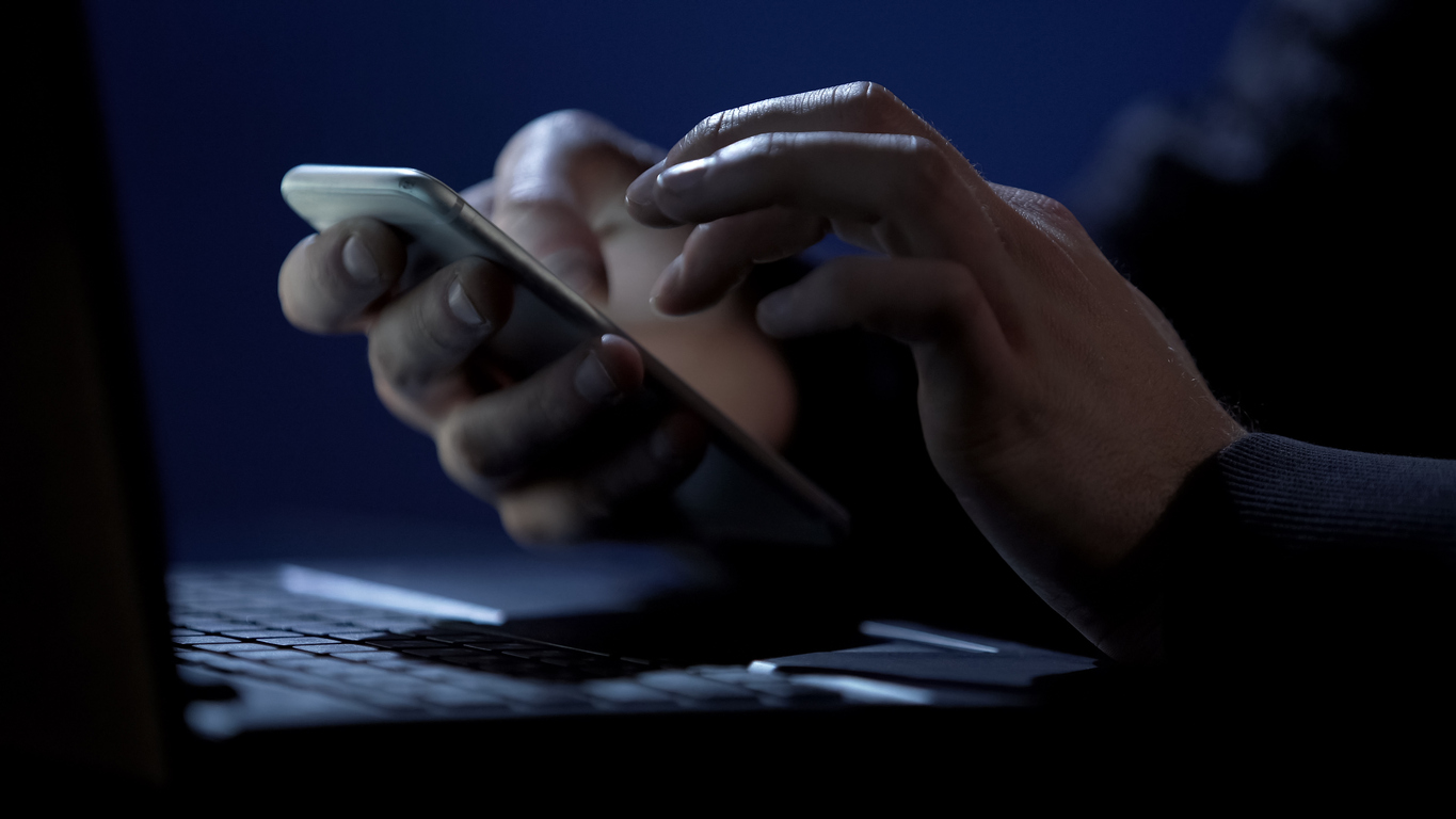 Scammer holds smartphone, cracks two-factor authentication, steals money online, stock footage