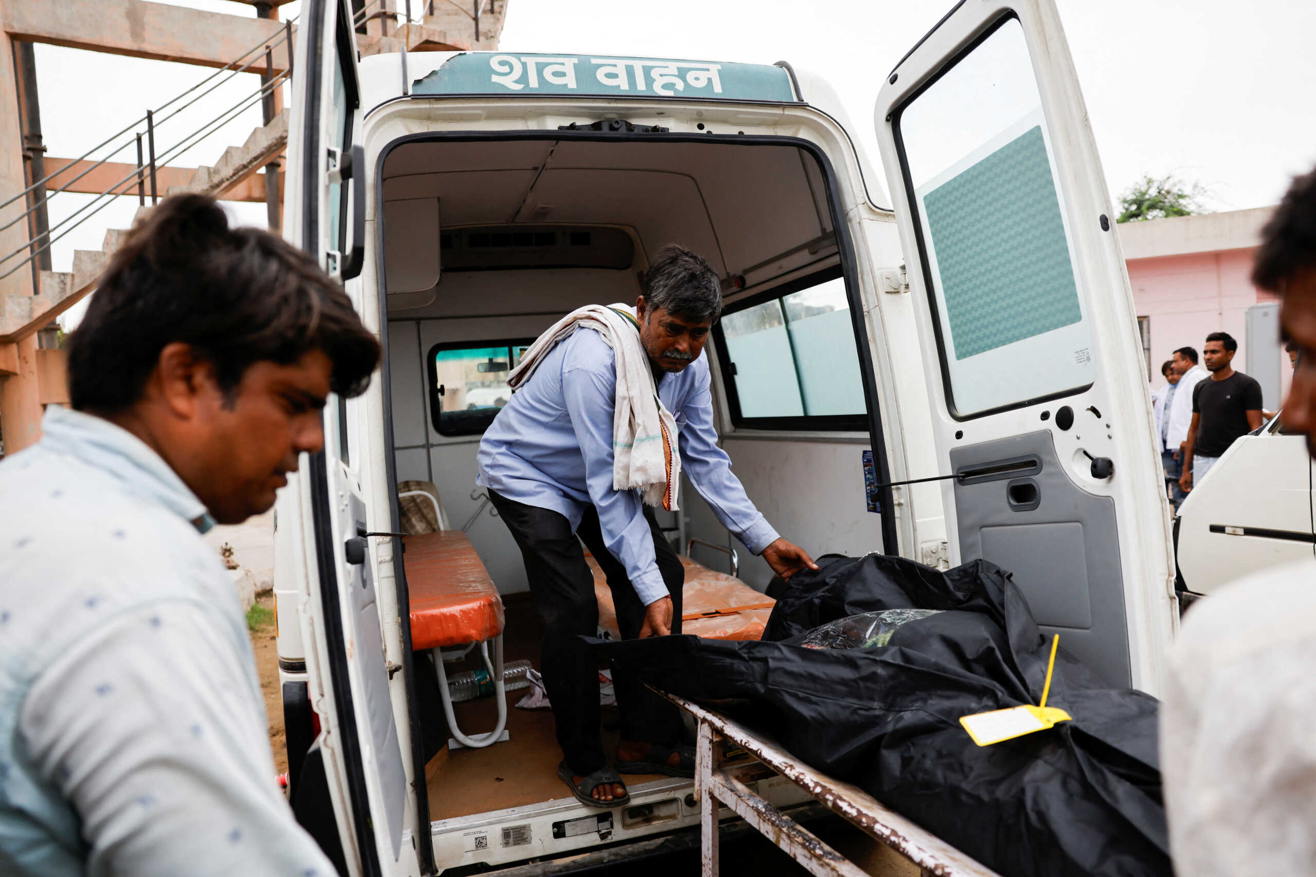 A man shifts the body of a stampede victim into an ambulance at a hospital in Hathras district of the northern state of Uttar Pradesh, India, July 3, 2024. REUTERS