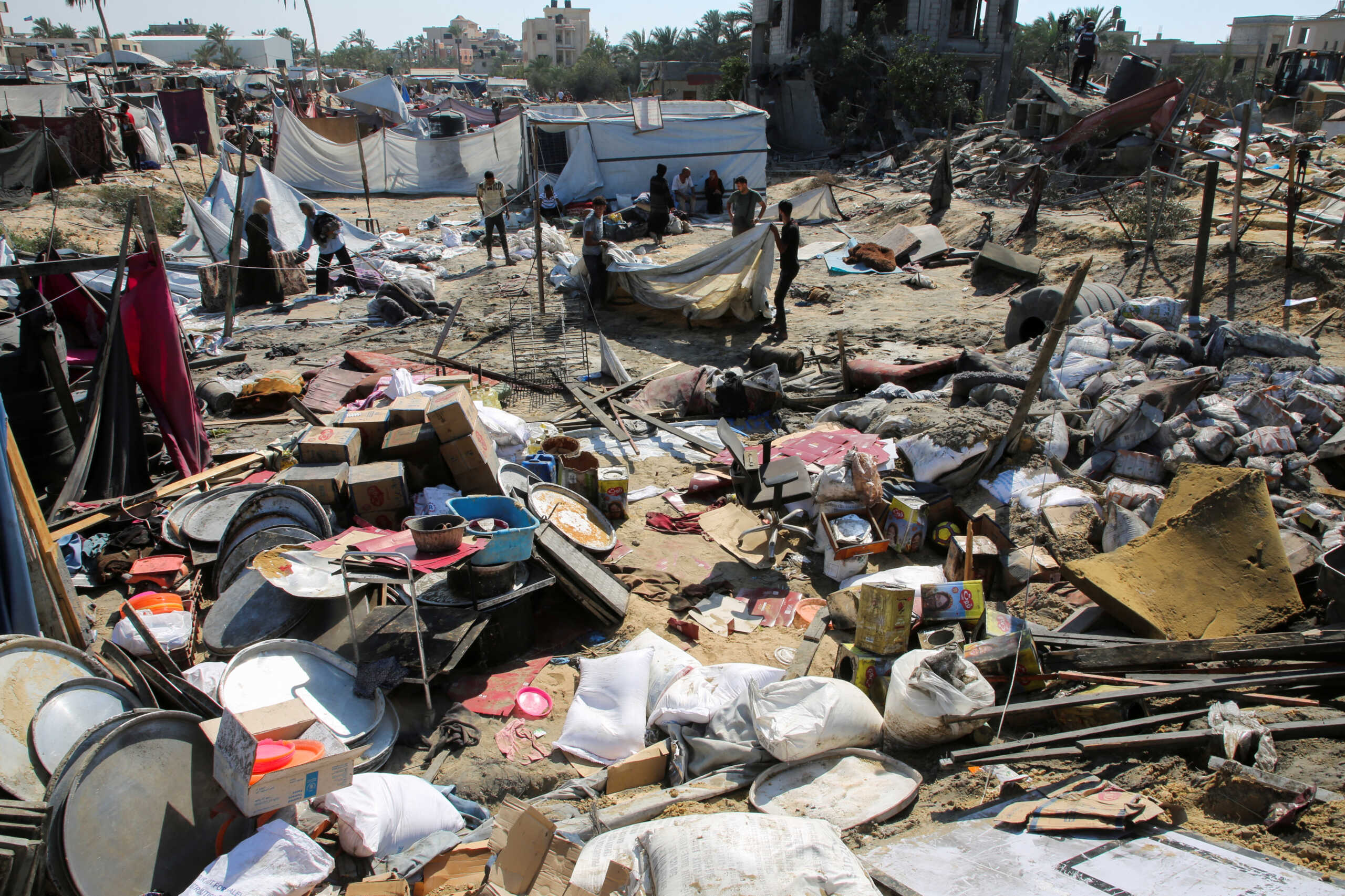 Palestinians inspect the damage following an Israeli strike at a tent camp in Al-Mawasi area, amid Israel-Hamas conflict, in Khan Younis in the southern Gaza Strip July 13, 2024. REUTERS