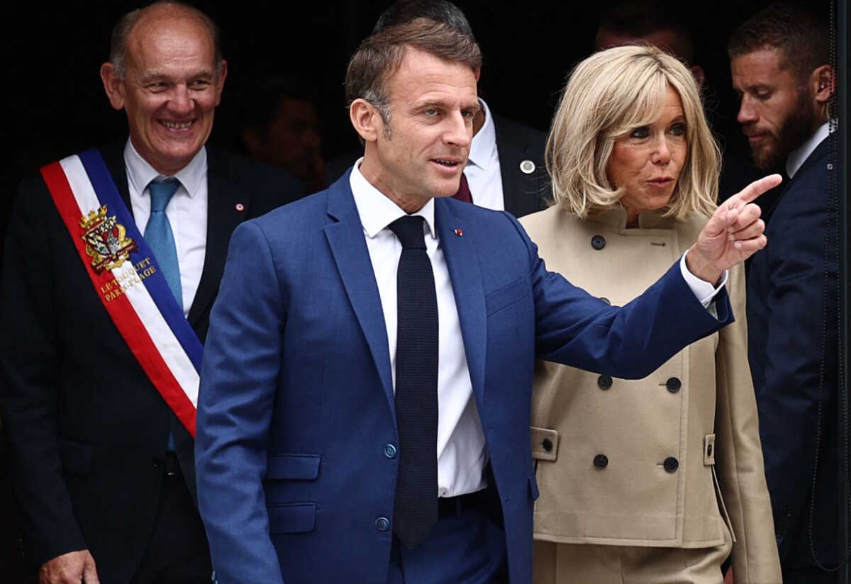 French President Emmanuel Macron and his wife Brigitte Macron leave a polling station, after voting in the first round of the early French parliamentary elections, in Le Touquet-Paris-Plage, France, June 30, 2024. REUTERS