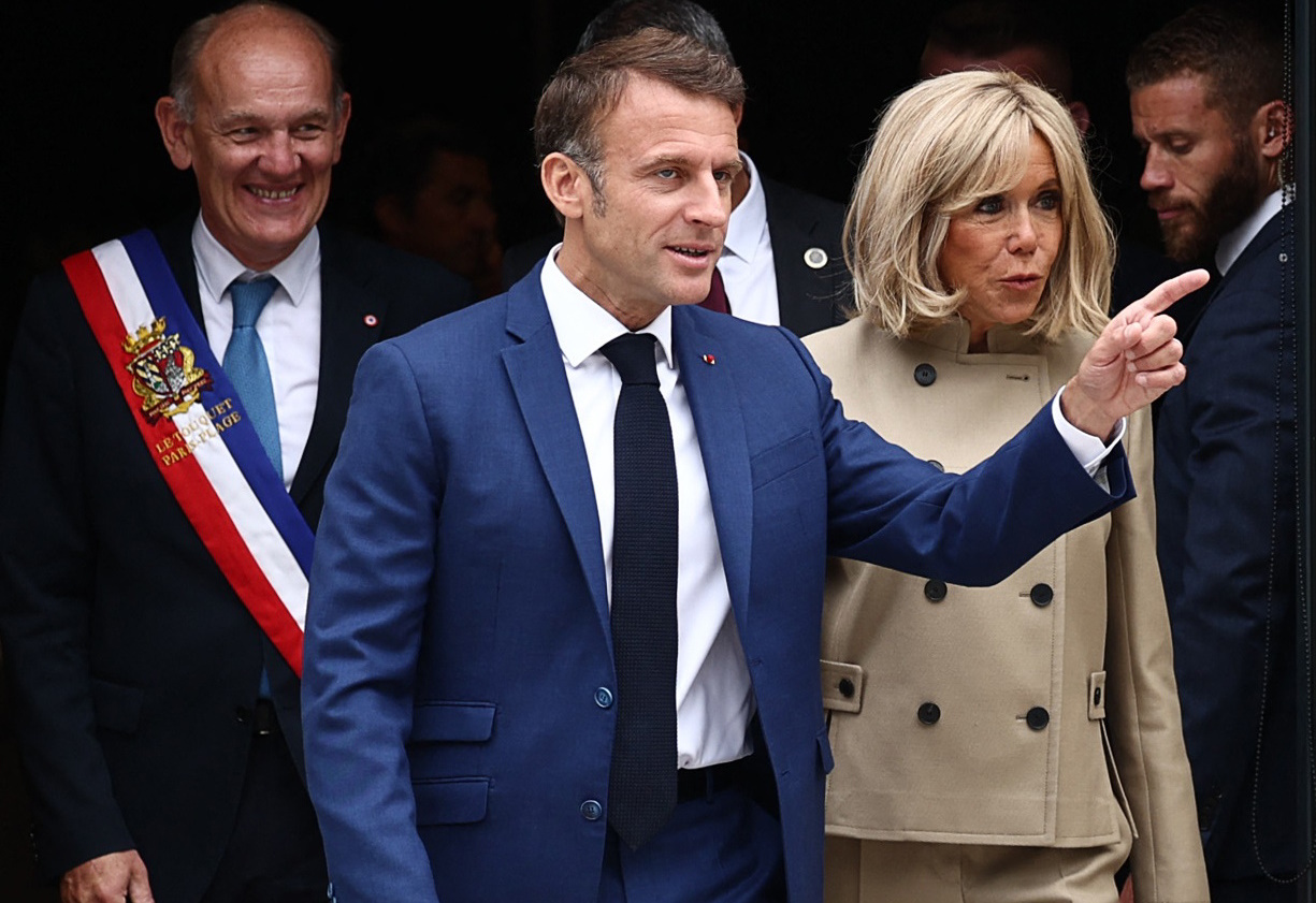 French President Emmanuel Macron and his wife Brigitte Macron leave a polling station, after voting in the first round of the early French parliamentary elections, in Le Touquet-Paris-Plage, France, June 30, 2024. REUTERS