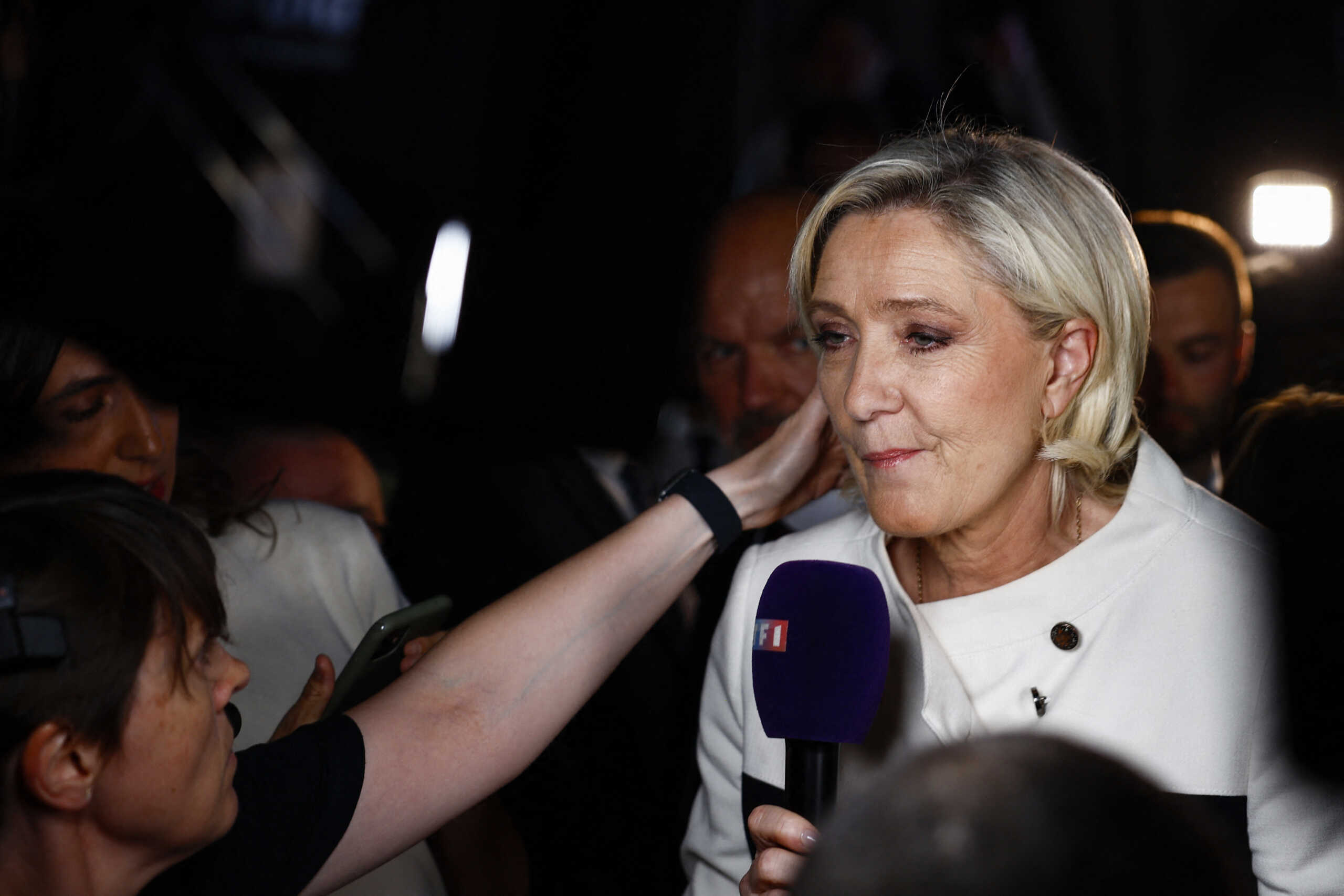 French far-right leader Marine Le Pen talks to journalists after partial results in the second round of the early French parliamentary elections, at the French far-right Rassemblement National (National Rally - RN) party venue in Paris, France, July 7, 2024. REUTERS
