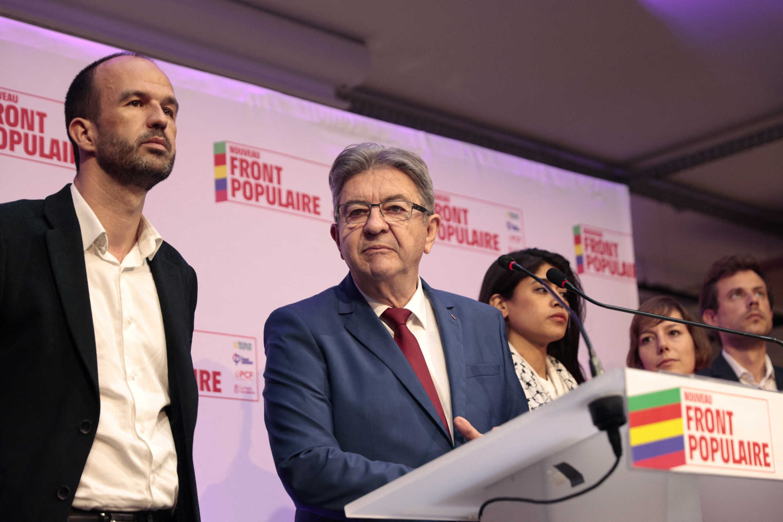Jean-Luc Melenchon, leader of French far-left opposition party La France Insoumise (France Unbowed - LFI), surrounded by Manuel Bompard and Rima Hassan, all members of the alliance of left-wing parties, called the "Nouveau Front Populaire" (New Popular Front - NFP), reacts on stage after partial results in the first round of the early French parliamentary elections at LFI headquarters in Paris, France, June 30, 2024. REUTERS