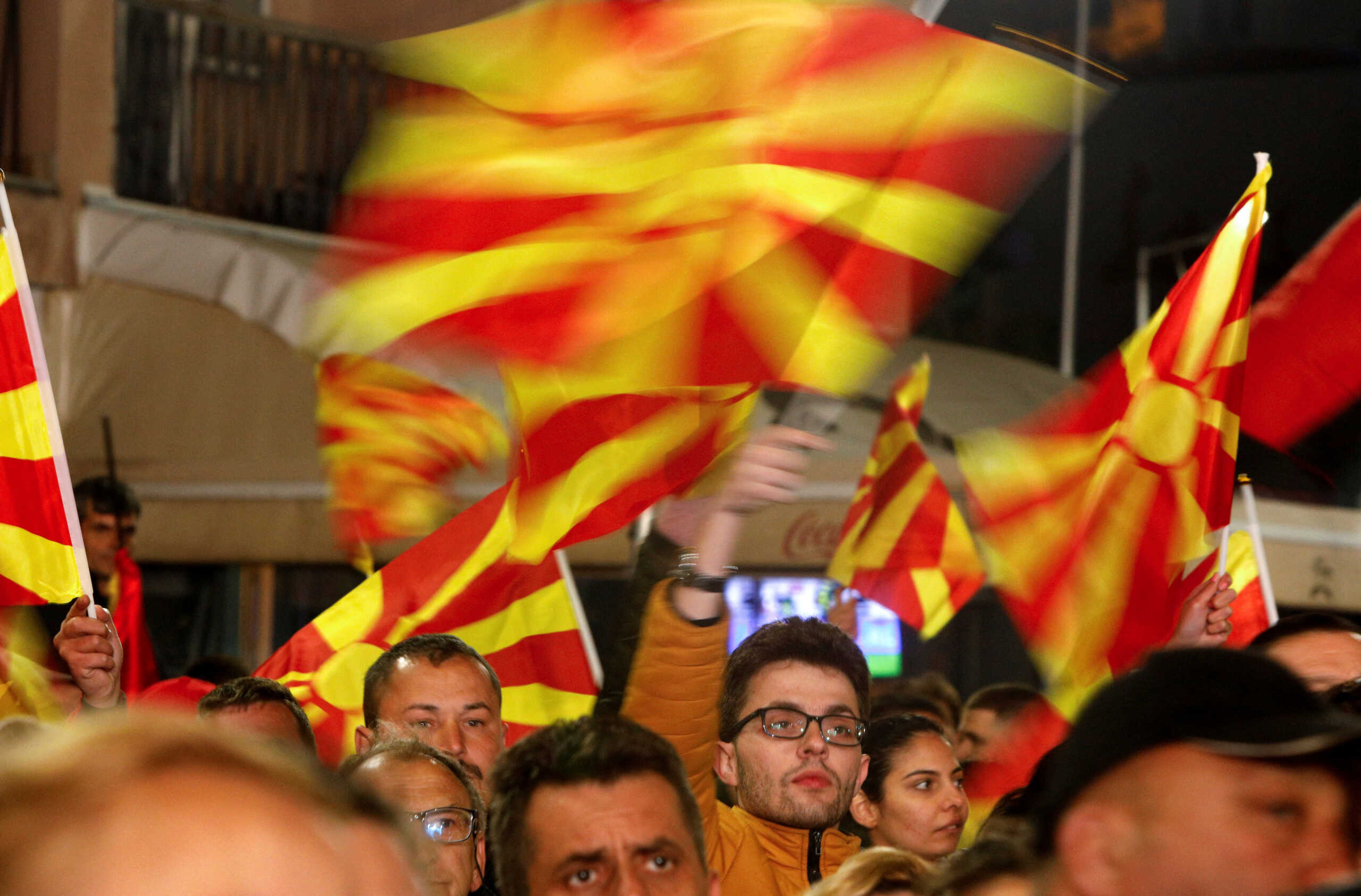 Supporters of the opposition party VMRO-DPMNE wave flags during an electoral meeting in Stip, North Macedonia April 22, 2024. REUTERS