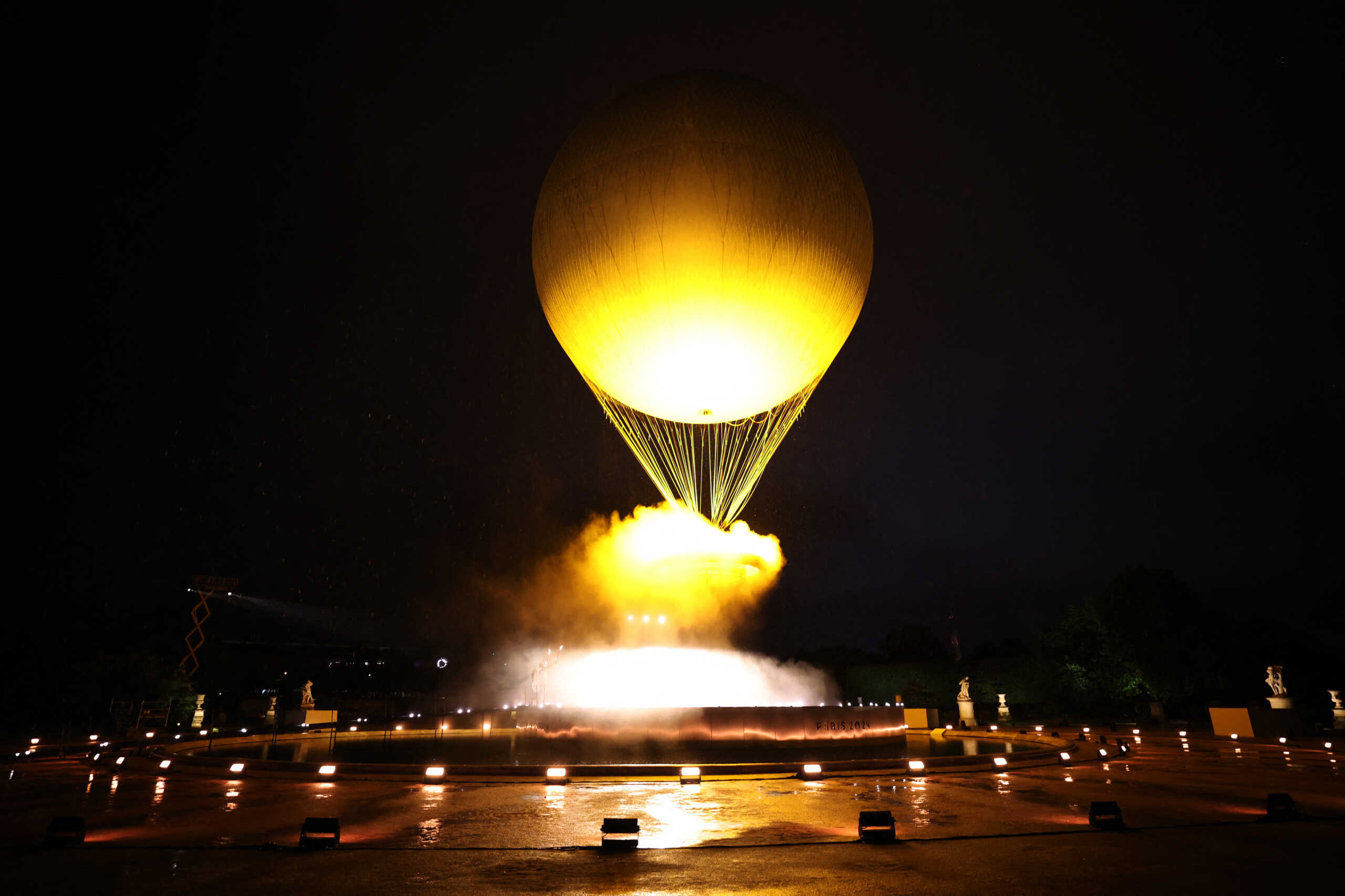 Paris 2024 Olympics - Opening Ceremony - Paris, France - July 26, 2024. A balloon carrying the lit Olympic cauldron flies at Jardin des Tuileries during the opening ceremony. REUTERS