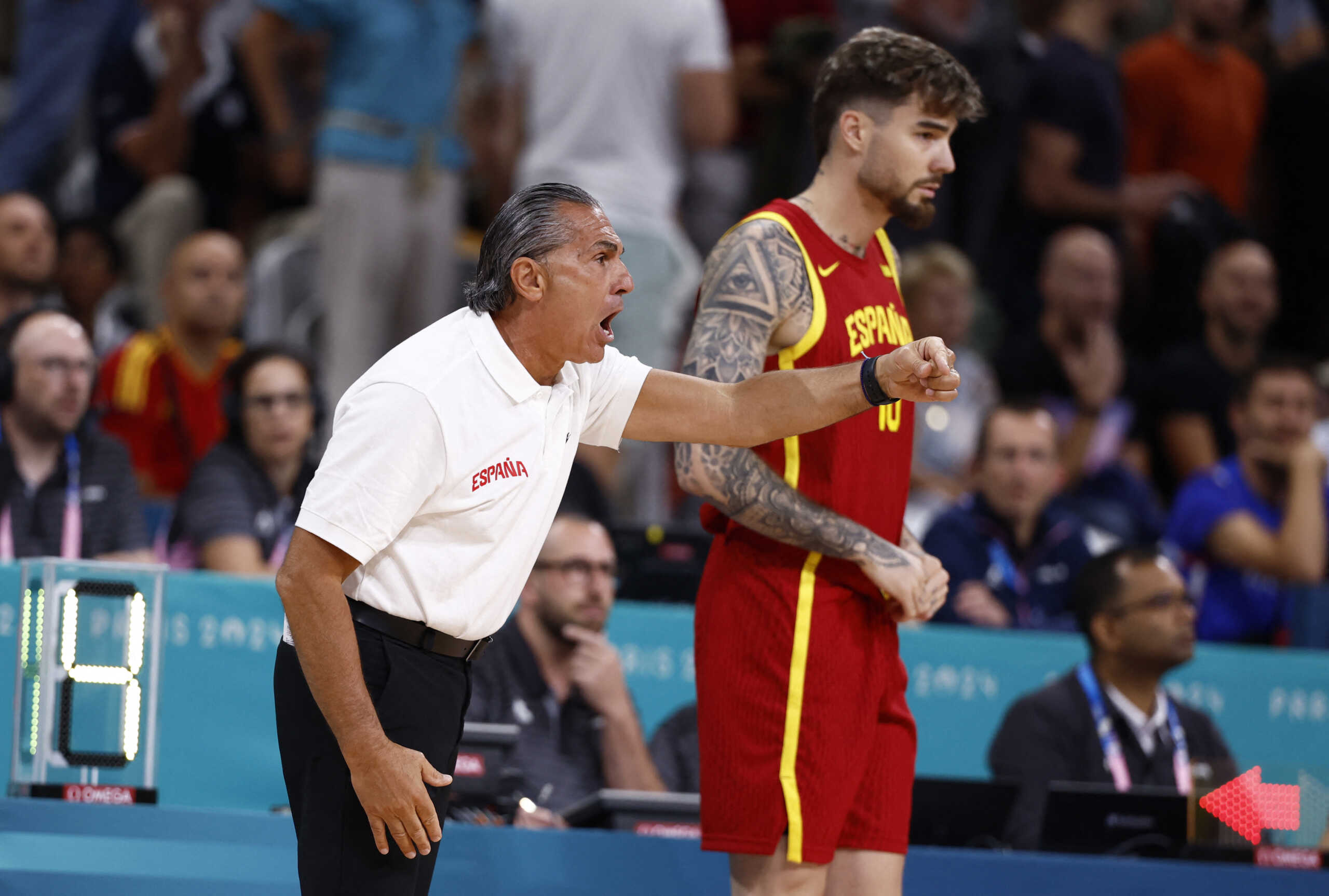 Paris 2024 Olympics - Basketball - Men's Group Phase - Group A - Australia vs Spain - Pierre Mauroy Stadium, Villeneve-d'Ascq, France - July 27, 2024. Spain's coach Sergio Scariolo of Italy reacts next to Juancho Hernangomez of Spain at Lille's Pierre Mauroy stadium in Villenuve D'Ascq REUTERS