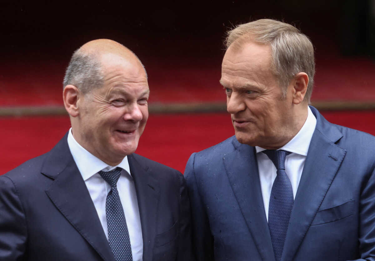 Polish Prime Minister Donald Tusk speaks with German Chancellor Olaf Scholz before the German-Polish inter-governmental consultations in front of Prime Minister Chancellery in Warsaw, Poland July 2, 2024. REUTERS
