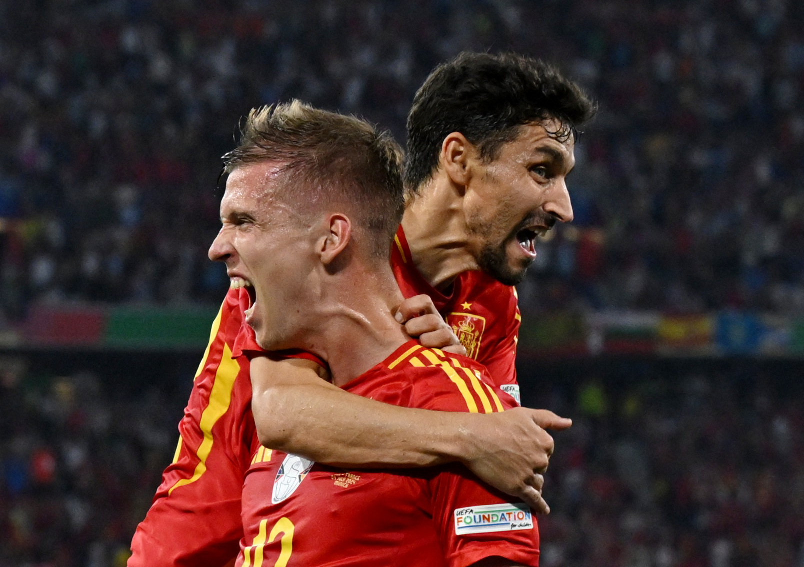 Soccer Football - Euro 2024 - Semi Final - Spain v France - Munich Football Arena, Munich, Germany - July 9, 2024  Spain's Dani Olmo celebrates their second goal with Jesus Navas, an own goal scored by France's Jules Kounde REUTERS
