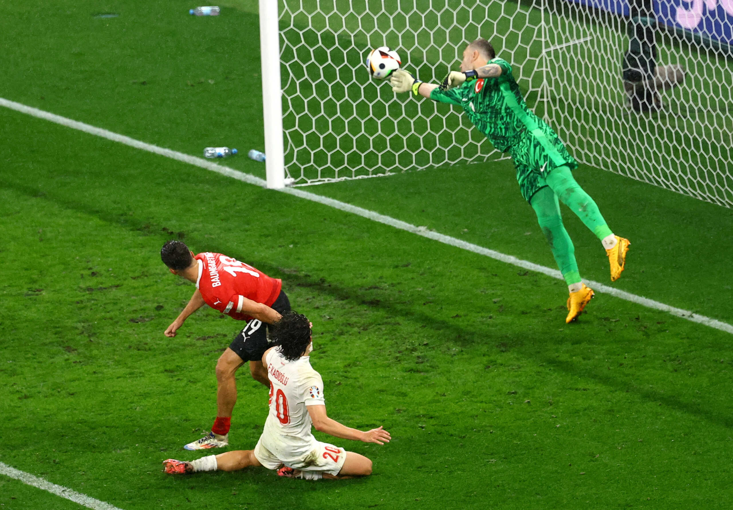 Soccer Football - Euro 2024 - Round of 16 - Austria v Turkey - Leipzig Stadium, Leipzig, Germany - July 2, 2024 Turkey's Mert Gunok makes a save from Austria's Christoph Baumgartner REUTERS