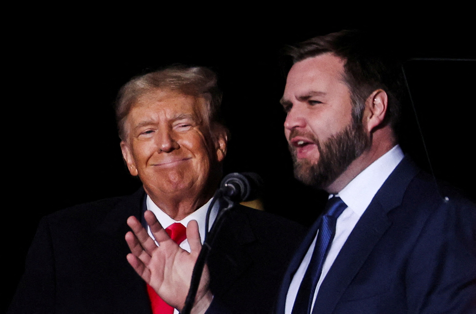 FILE PHOTO: U.S. Senate Republican candidate J.D. Vance speaks as former U.S. President Donald Trump smiles at a rally to support Republican candidates ahead of midterm elections, in Dayton, Ohio, U.S. November 7, 2022.  REUTERS