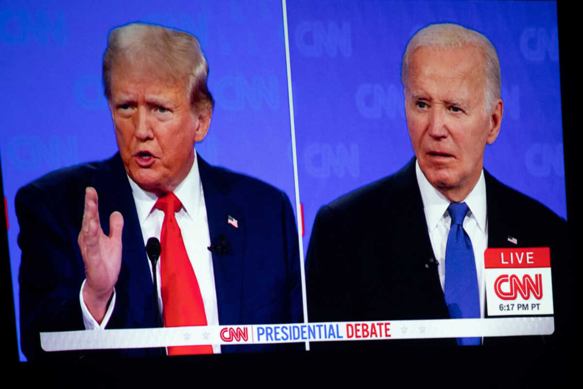 FILE PHOTO: The first presidential debate between U.S. President Joe Biden and former U.S. President and Republican presidential candidate Donald Trump is projected on a screen projector during a watch party hosted by the Michigan Conservative Coalition in Novi, Michigan, U.S., June 27, 2024.     REUTERS