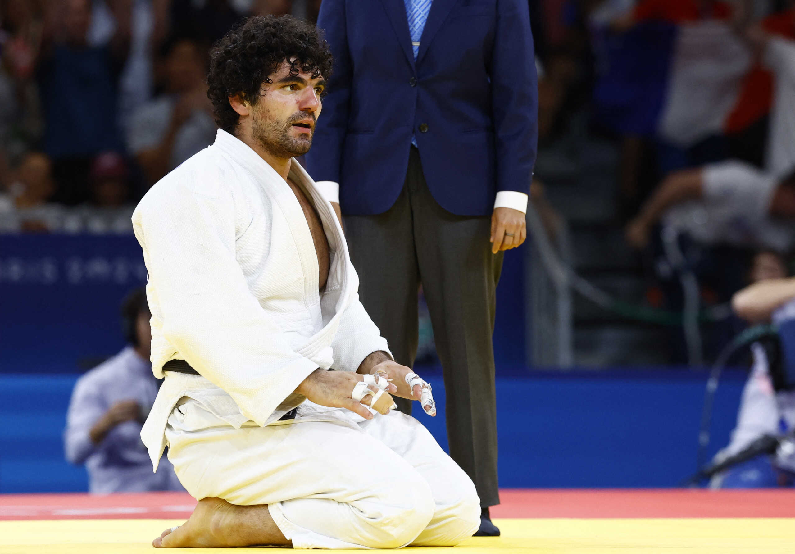 Paris 2024 Olympics - Judo - Men -90 kg Quarterfinals - Champ de Mars Arena, Paris, France - July 31, 2024. Theodoros Tselidis of Greece reacts after losing to Maxime-Gael Ngayap Hambou of France. REUTERS