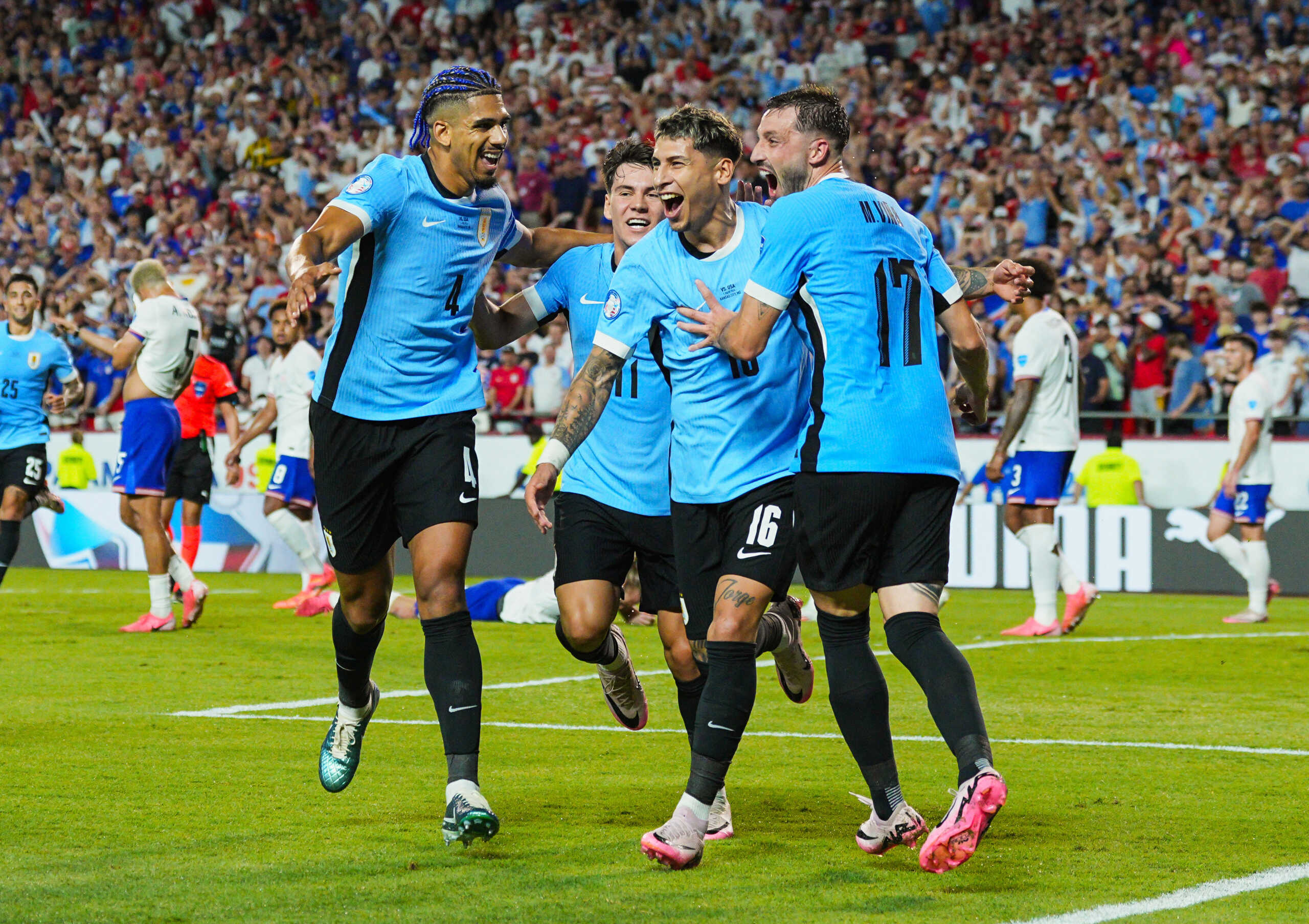 Jul 1, 2024; Kansas City, Missouri, USA; Uruguay defender Mathias Olivera (16) celebrates with teammates after scoring a goal during the second half of a Copa America match against the United States at Arrowhead Stadium. Mandatory Credit: Jay Biggerstaff-USA TODAY Sports