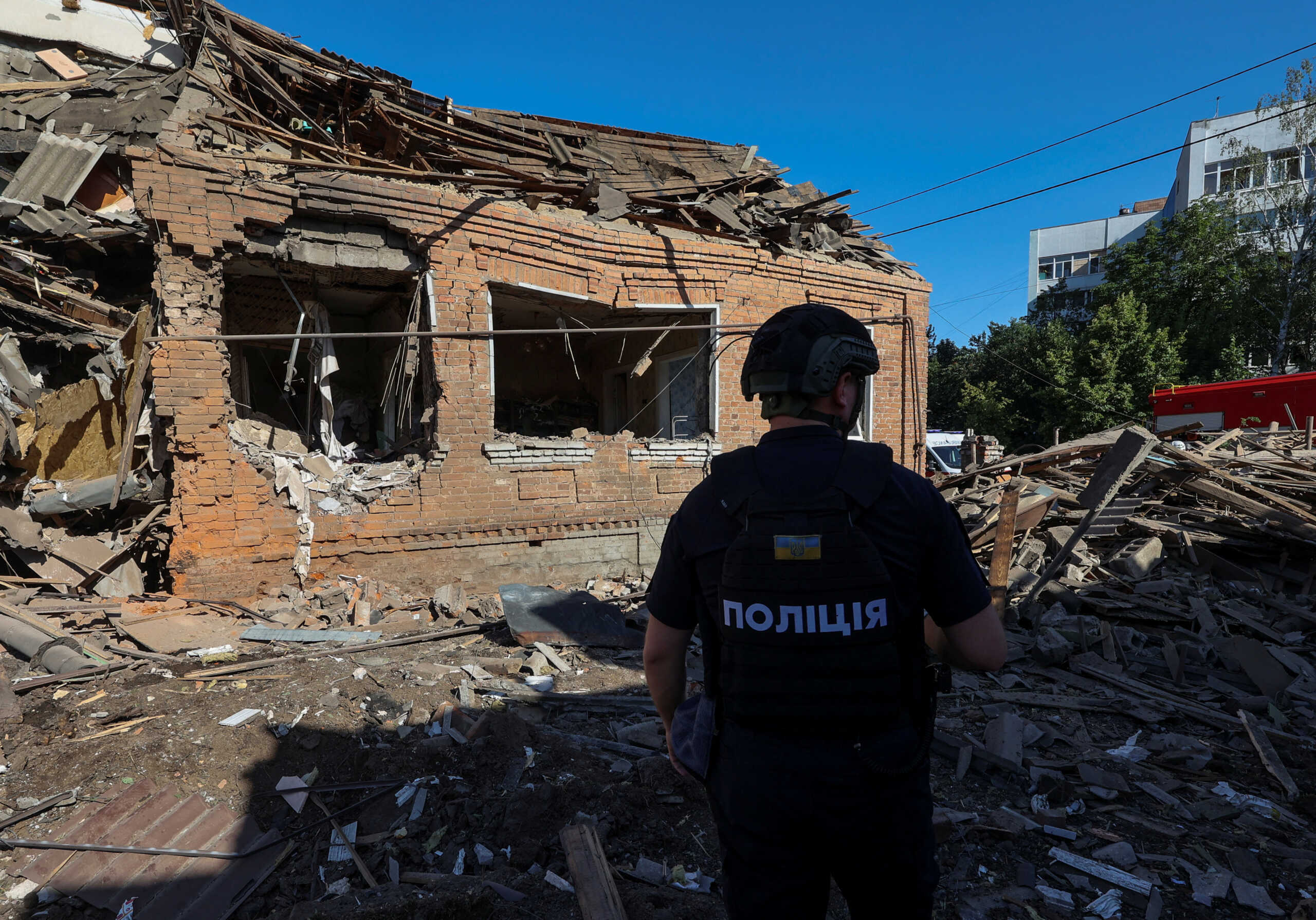 A police officer inspects the site where a residential building was heavily damaged by a Russian air strike, amid Russia's attack on Ukraine, in Kharkiv, Ukraine July 3, 2024. REUTERS