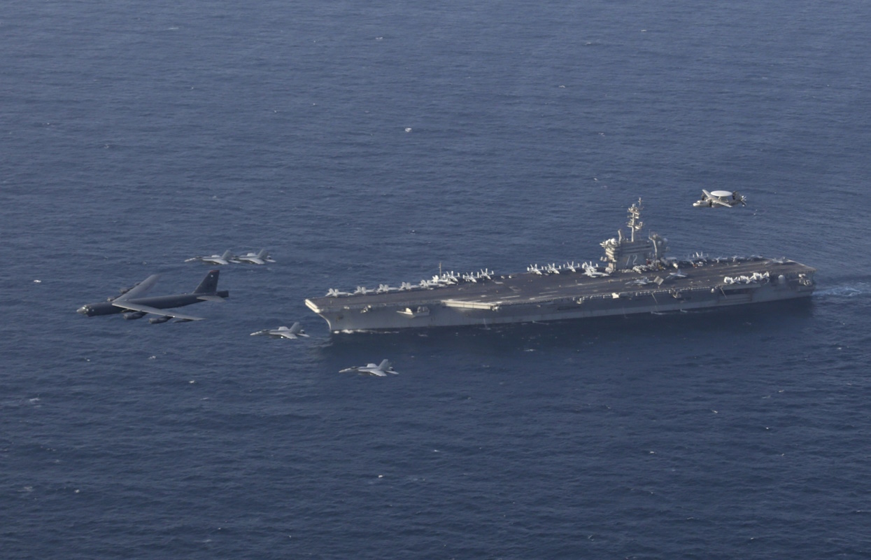 FILE - In this June 1, 2019 file photo, the USS Abraham Lincoln carrier and a U.S. Air Force B-52H Stratofortress, conduct joint exercises in the U.S. Central Command area of responsibility in Arabian sea. The Abraham Lincoln that the White House ordered to the Mideast over a perceived threat from Iran remains outside of the Persian Gulf amid efforts to de-escalate tensions between Tehran and Washington. (Mass Communication Specialist 1st Class Brian M. Wilbur