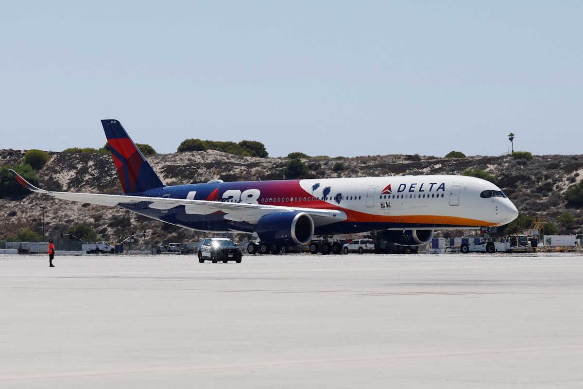 A Delta Airlines jet carrying American athletes and officials and the Olympic flag arrives in Los Angeles, California, U.S. August 12, 2024. REUTERS