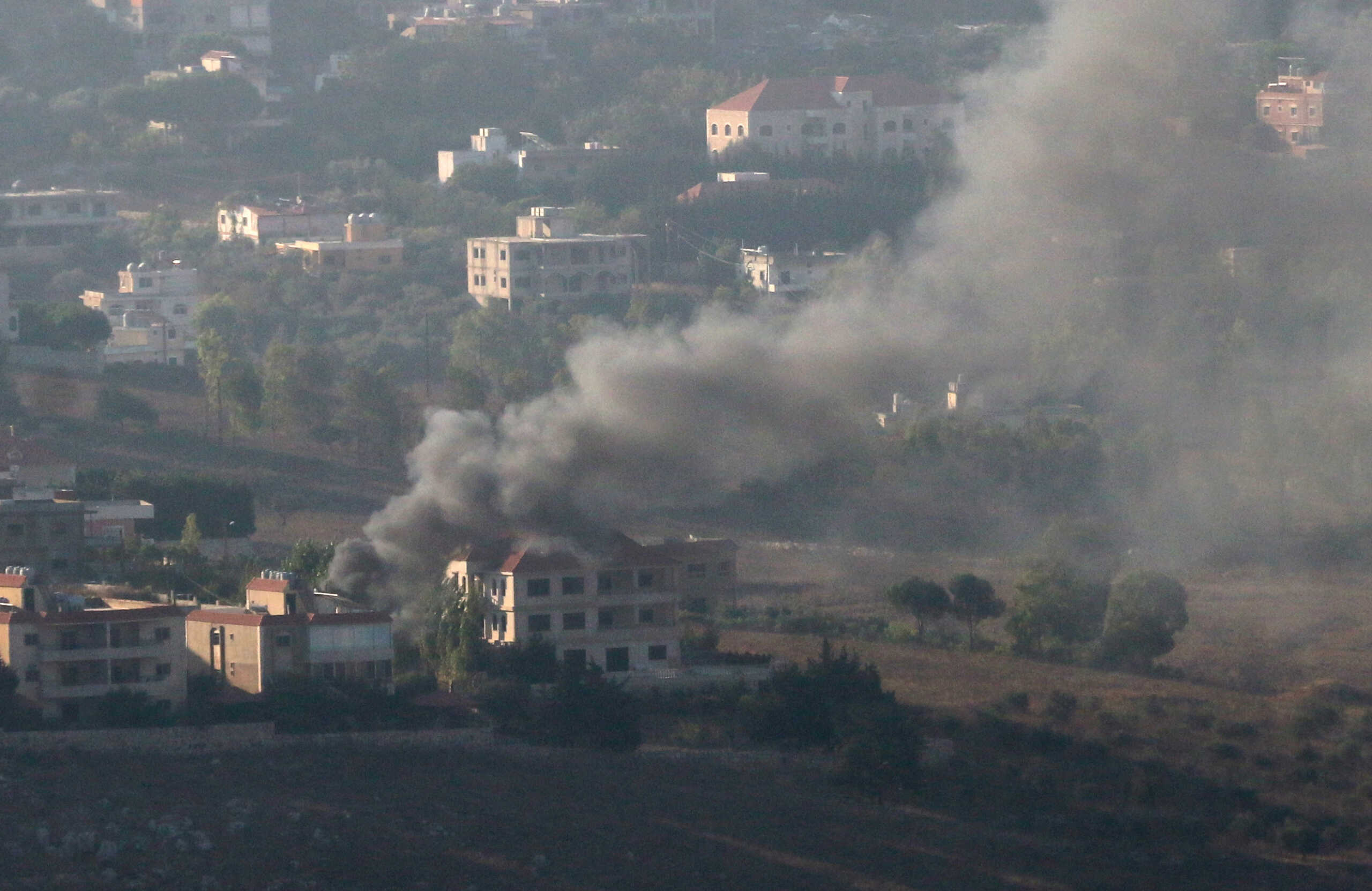 Smoke rises from the southern Lebanese town of Khiam, amid ongoing cross-border hostilities between Hezbollah and Israeli forces, as pictured from Marjayoun, near the border with Israel, August 25, 2024. REUTERS