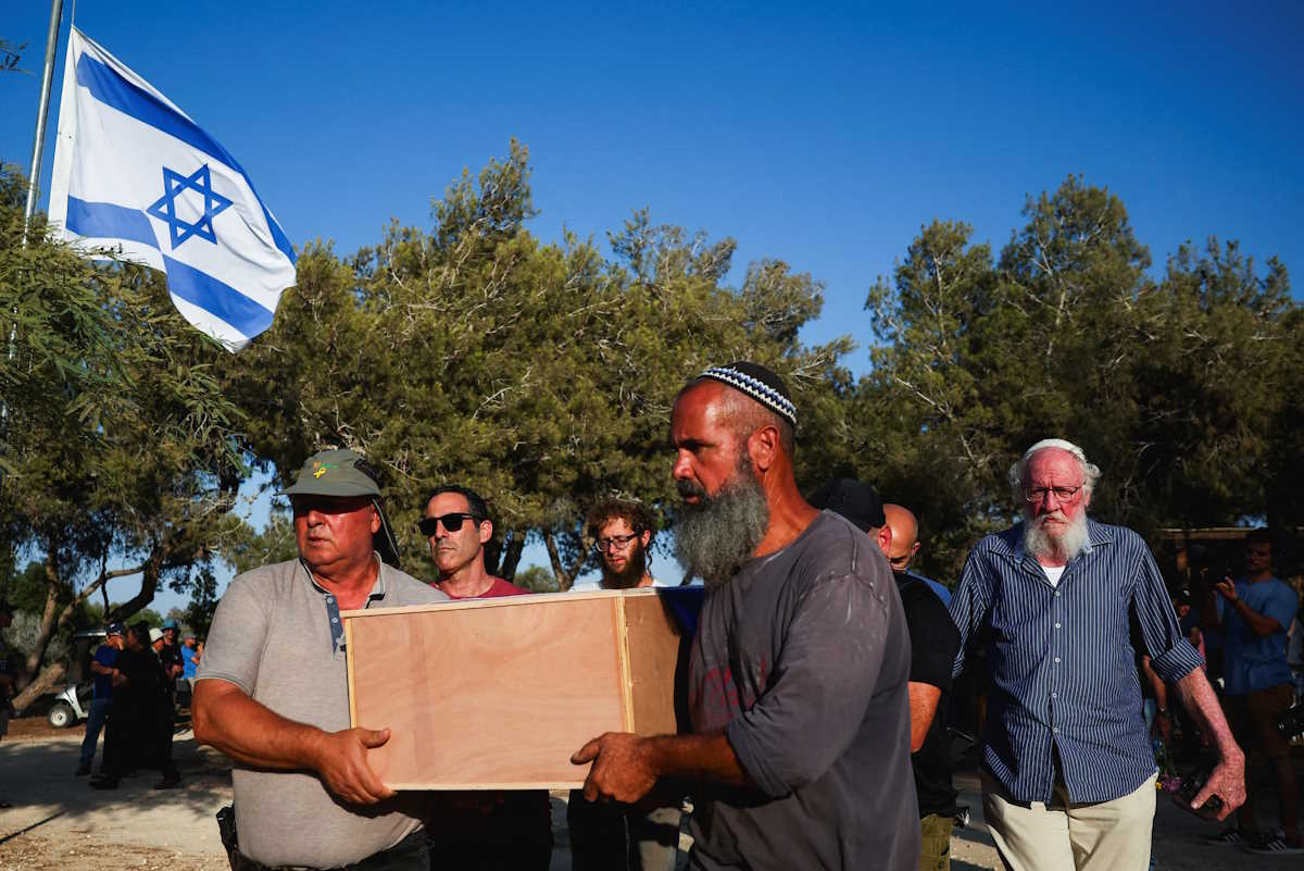 Mourners carry the coffin of Yoram Metzger, one of the six hostages whose bodies were retrieved from Gazan captivity and brought to Israel in a military operation, at his funeral in Kibbutz Nir Oz, southern Israel, August 22, 2024. REUTERS