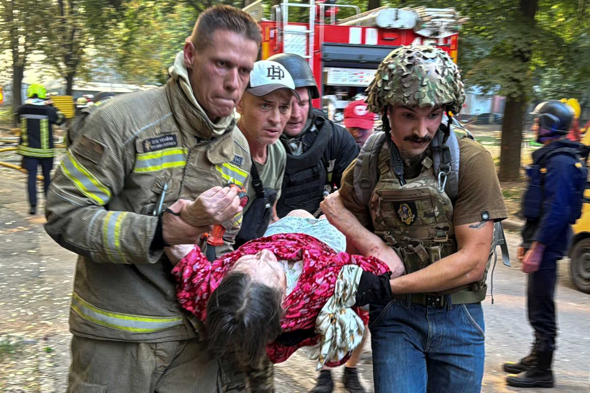 Paramedics carry a person rescued from an apartment building which burns after a Russian air strike, amid Russia's attack on Ukraine, in Kharkiv, Ukraine August 30, 2024. REUTERS