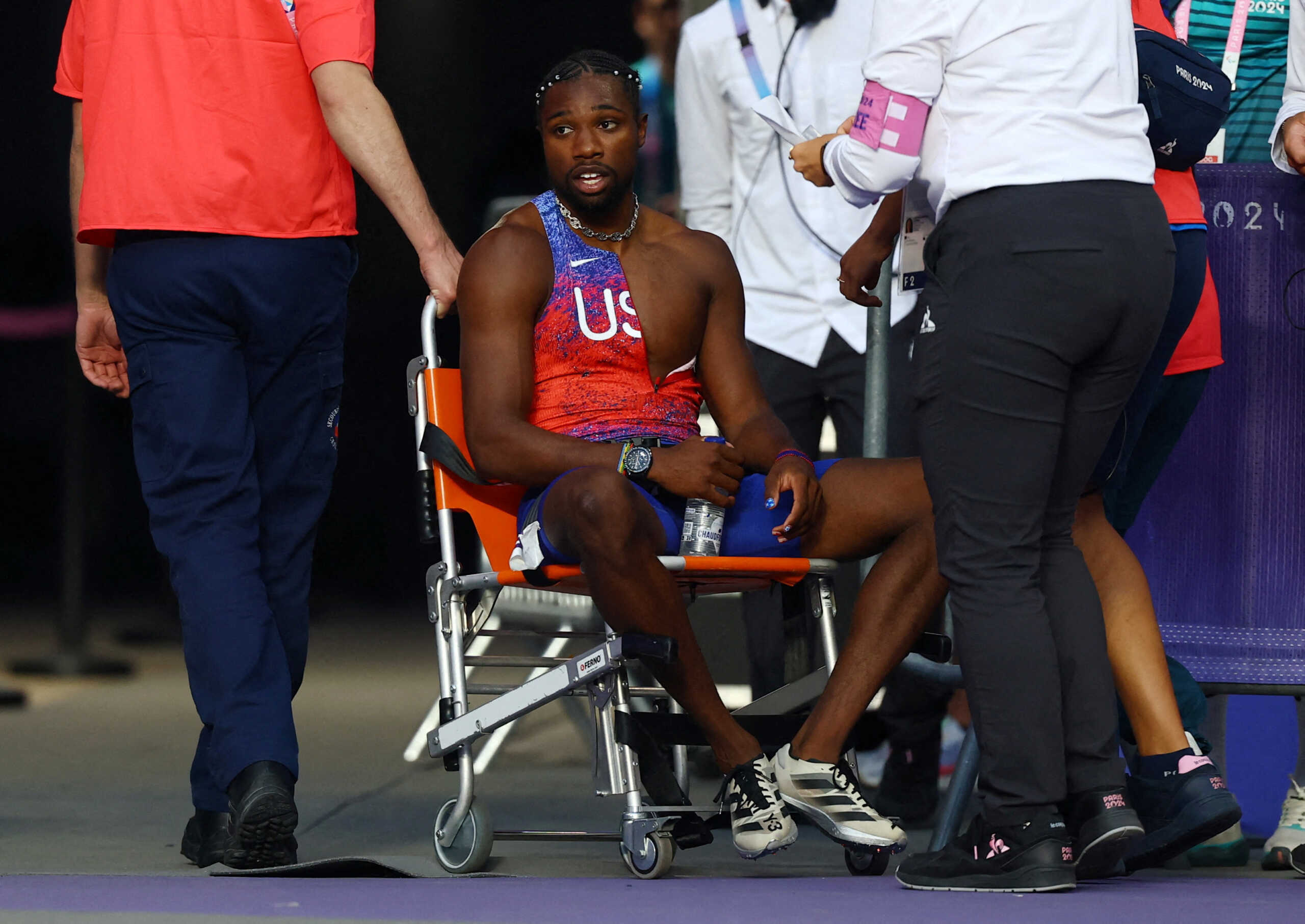 Paris 2024 Olympics - Athletics - Men's 200m Final - Stade de France, Saint-Denis, France - August 08, 2024.  Noah Lyles of United States receives medical attention after winning bronze REUTERS