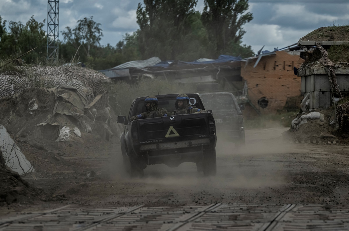 Ukrainian servicemen ride military vehicles at a crossing point on the border with Russia, amid Russia's attack on Ukraine, in Sumy region, Ukraine August 13, 2024. REUTERS