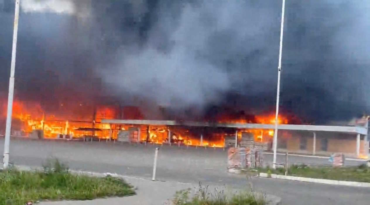 Smoke and flames rise from a shopping center damaged by shelling in the course of the Russia-Ukraine conflict, in Donetsk, Russian-controlled Ukraine, in this screengrab taken from a video released on August 16, 2024. Video Obtained by Reuters. THIS IMAGE HAS BEEN SUPPLIED BY A THIRD PARTY. NO RESALES. NO ARCHIVES.