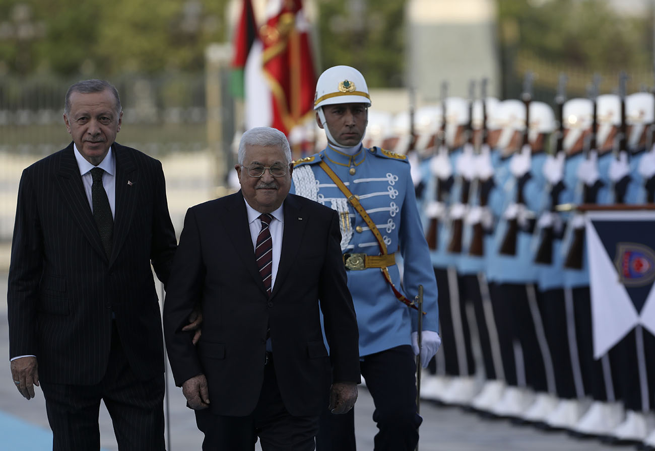 Turkey's President Recep Tayyip Erdogan, left, and Palestinian President Mahmoud Abbas review a military honour guard during a welcome ceremony in Ankara, Turkey, Tuesday, Aug. 23, 2022. Abbas is in Turkey for a two-day state visit. (AP Photo