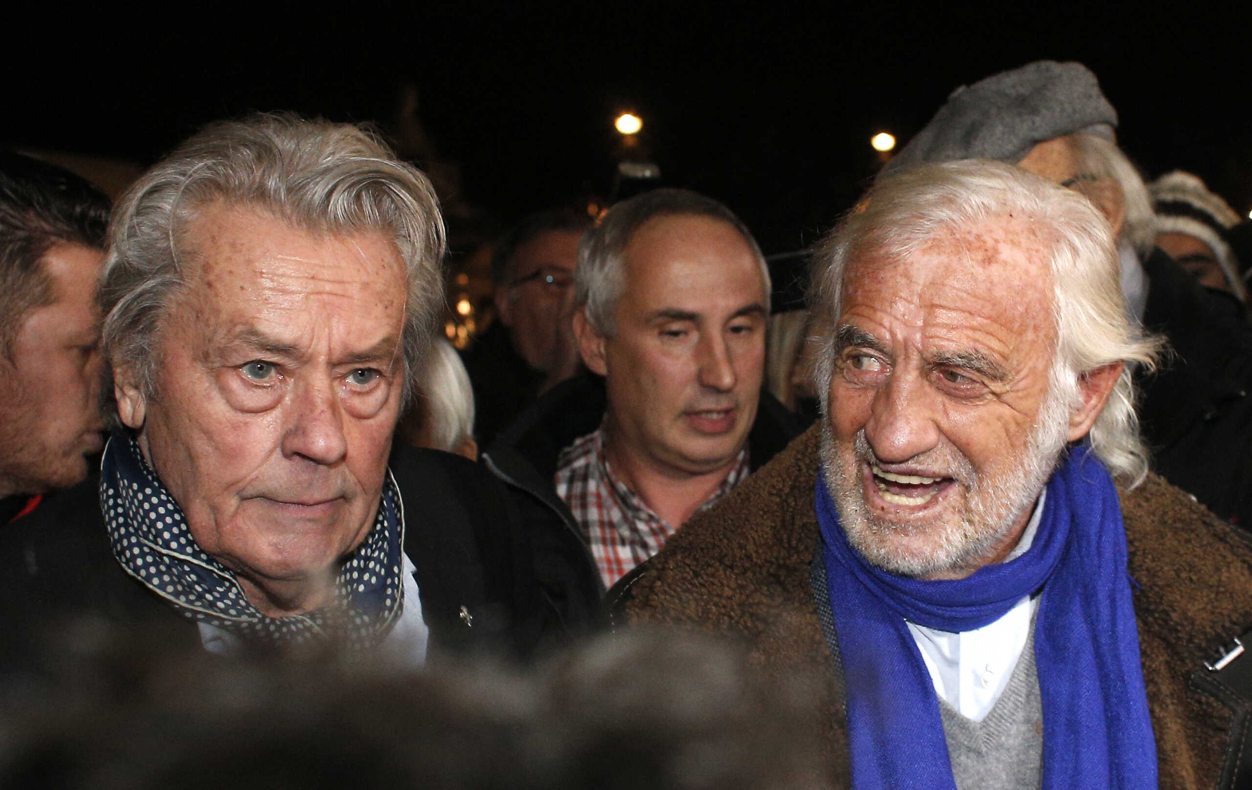 French actors Alain Delon, left, and Jean Paul Belmondo, center, right, arrive for the inauguration of a giant Ferris wheel, in Paris, Friday, Nov. 17, 2017. (AP Photo