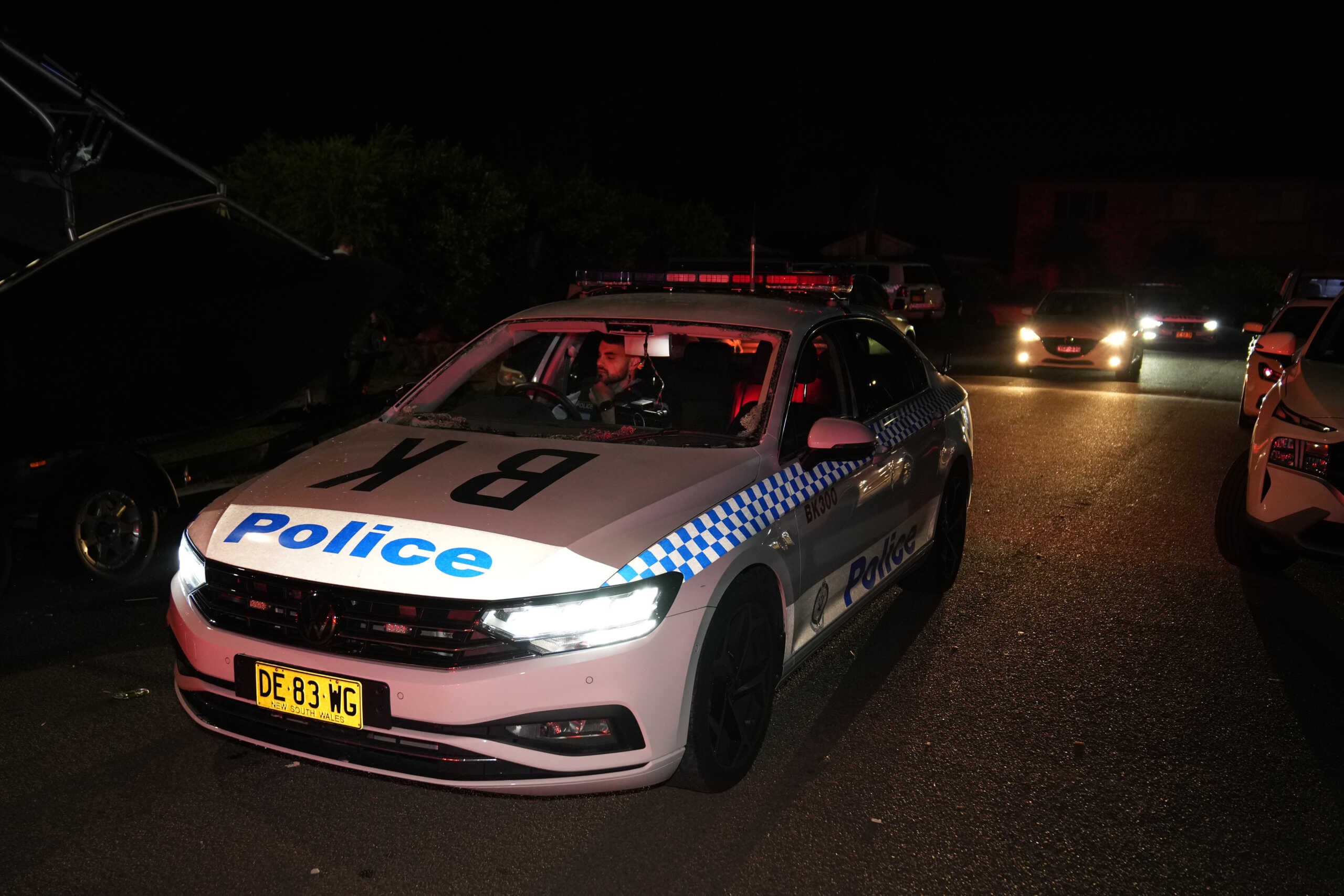 Policemen drive a car which was vandalized outside a church where a bishop and churchgoers were reportedly stabbed in Sydney Australia, Monday, April 15, 2024. Police in Australia say a man has been arrested after a bishop and churchgoers were stabbed in the church. There are no life-threatening injuries. (AP Photo