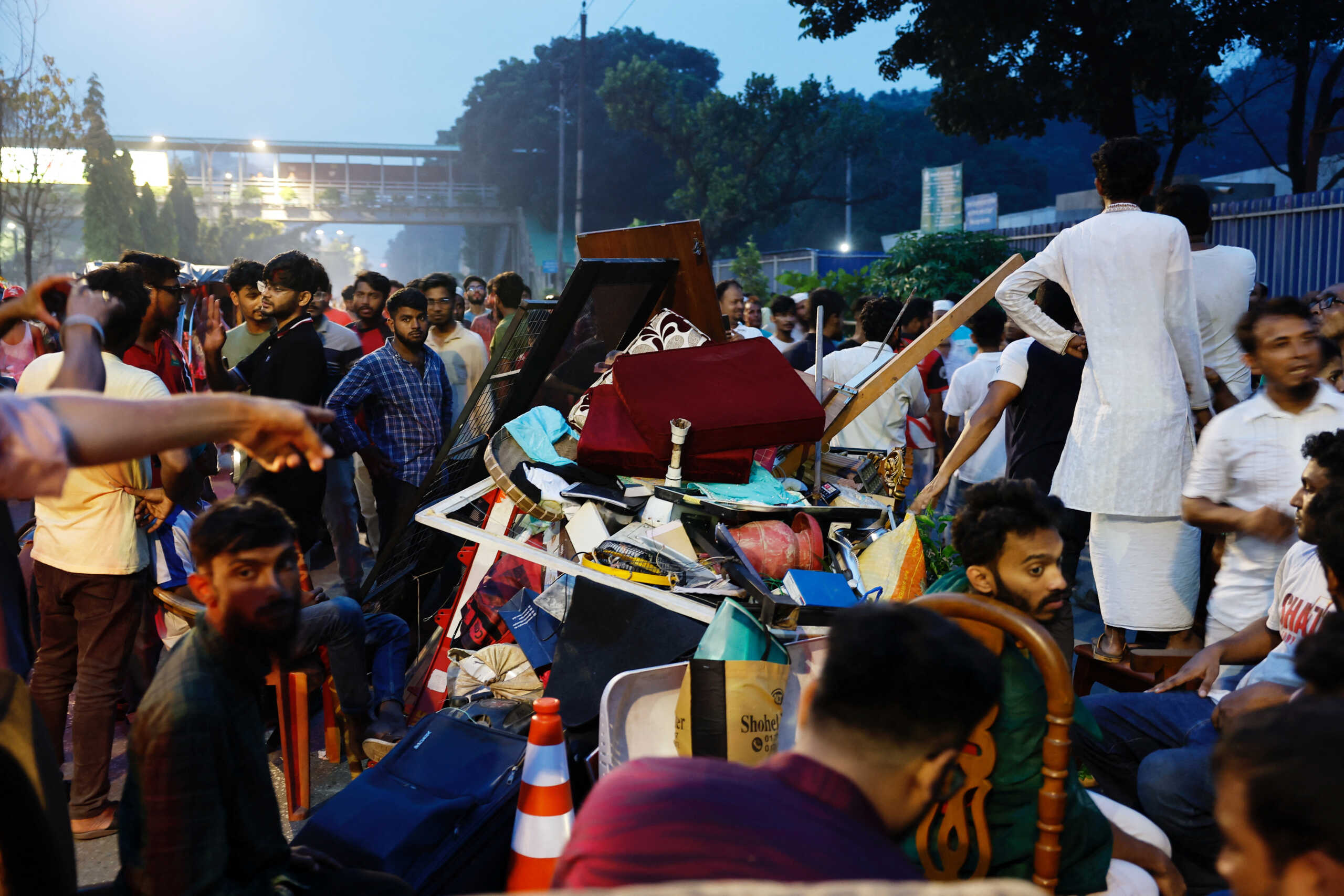 Men collect items that were looted from Ganabhaban, the Prime Minister's residence, in order to return them, after the resignation of PM Sheikh Hasina in Dhaka, Bangladesh, August 5, 2024. REUTERS