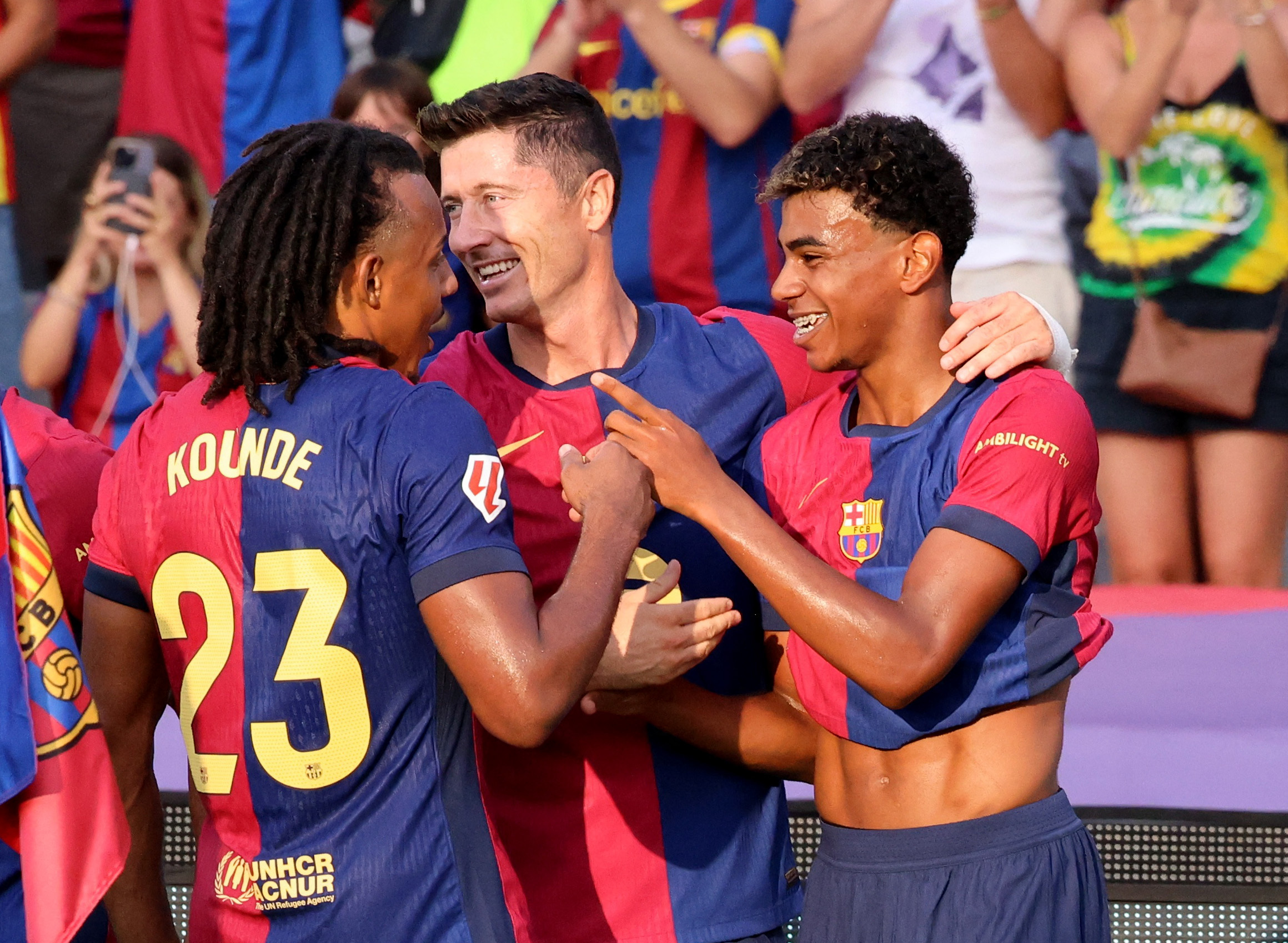 Soccer Football - LaLiga - FC Barcelona v Athletic Bilbao - Estadi Olimpic Lluis Companys, Barcelona, Spain - August 24, 2024 FC Barcelona's Lamine Yamal celebrates scoring their first goal with Robert Lewandowski and Jules Kounde REUTERS