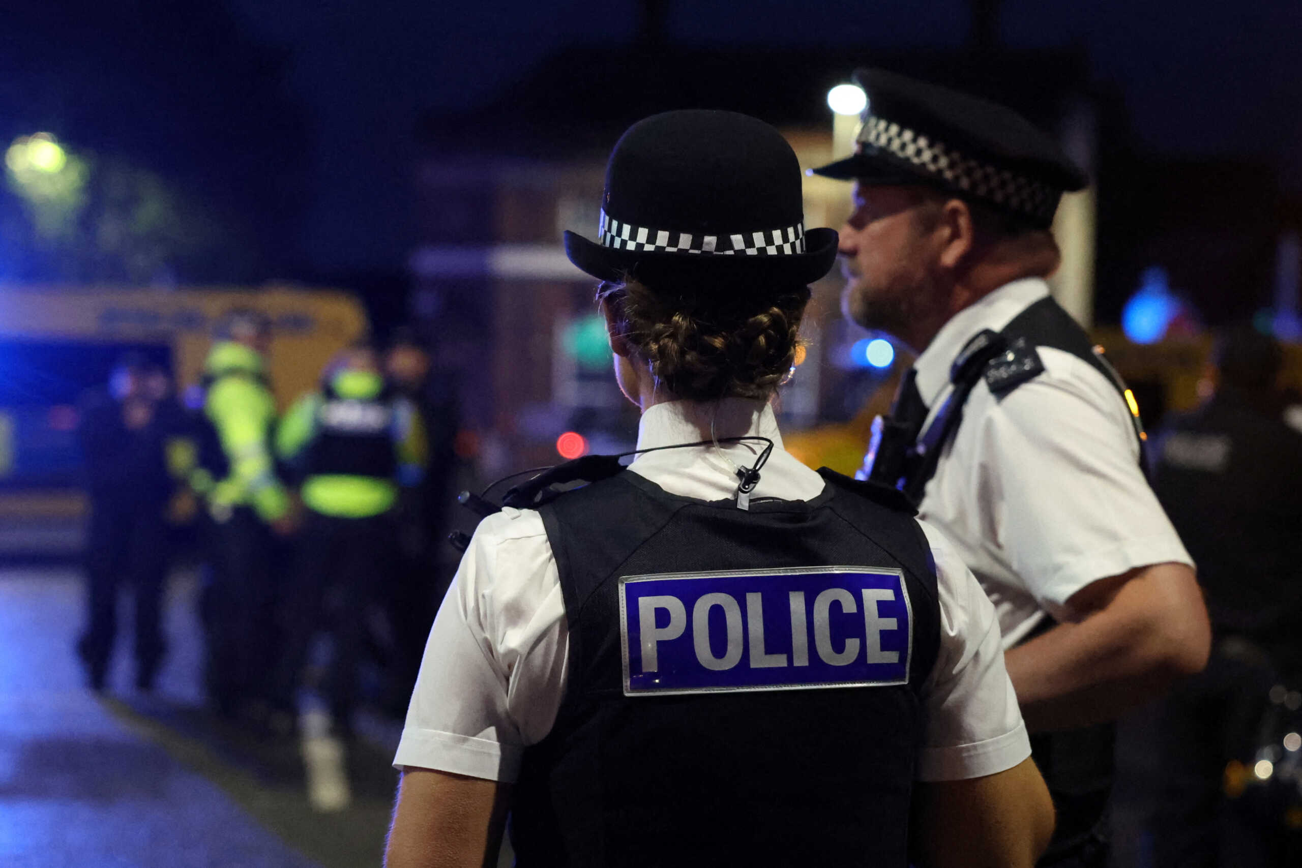 Police officers stand guard as people take part in a protest outside a mosque in Liverpool, Britain, August 2, 2024. REUTERS