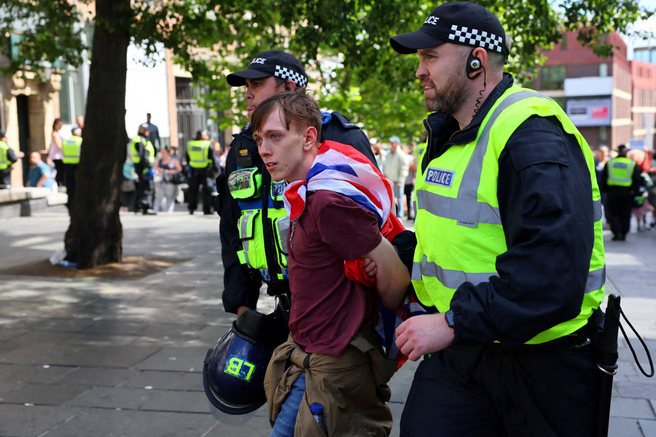 FILE PHOTO: An anti-immigration protester is detained by police officers, in Newcastle, Britain August 10, 2024. REUTERS
