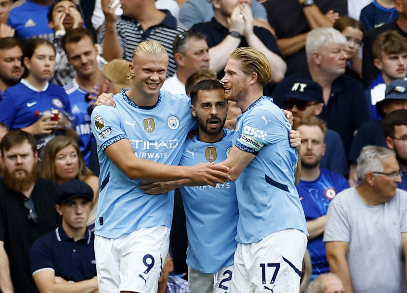Soccer Football - Premier League - Chelsea v Manchester City - Stamford Bridge, London, Britain - August 18, 2024 Manchester City's Erling Haaland celebrates scoring their first goal with Bernardo Silva and Kevin De Bruyne Action Images via Reuters