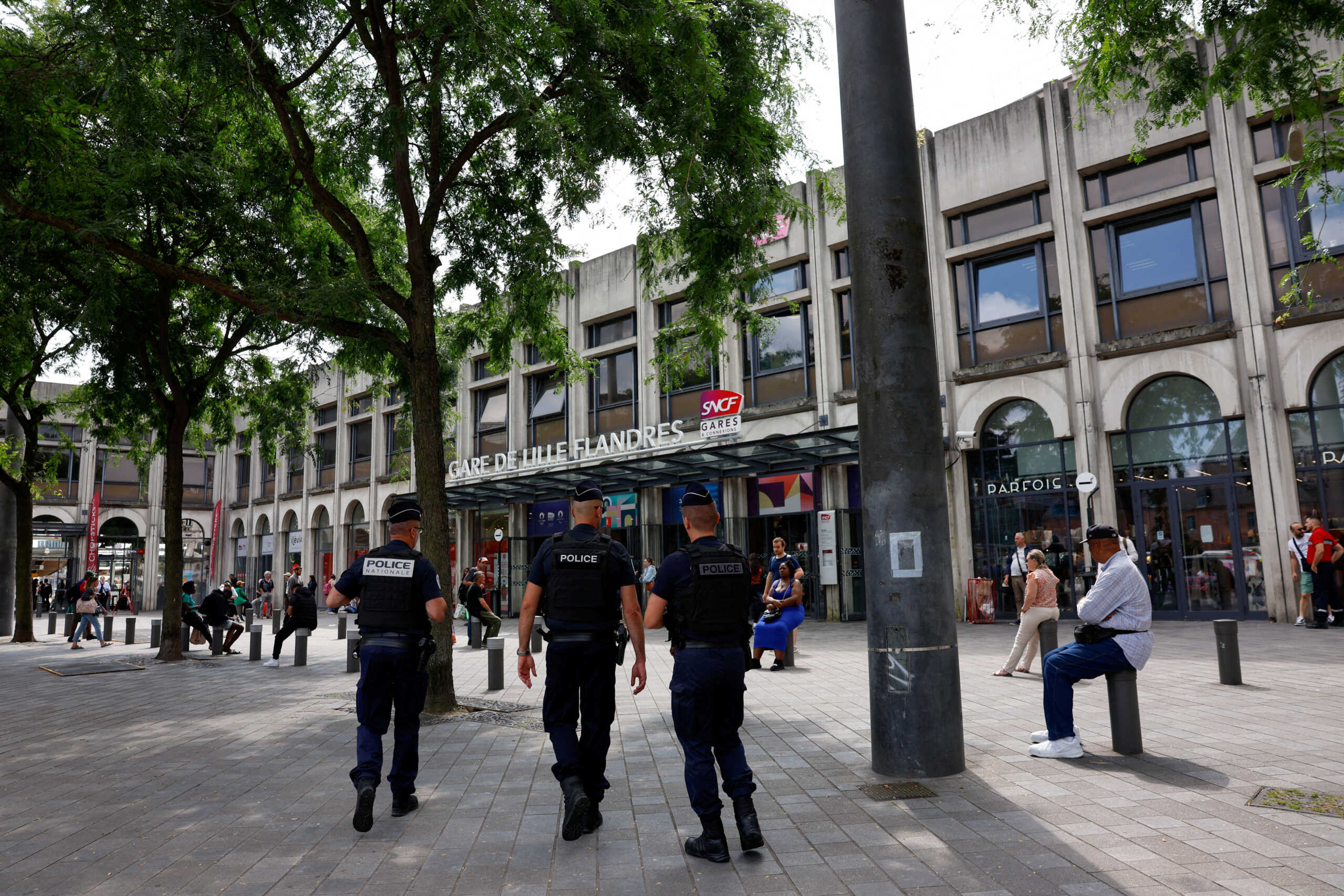 Police officers walk outside the Gare de Lille-Flandres train station, after a series of coordinated actions on France's high-speed train network that brought major disruption, ahead of the Paris 2024 Olympics opening ceremony, in Lille, France, July 26, 2024. REUTERS